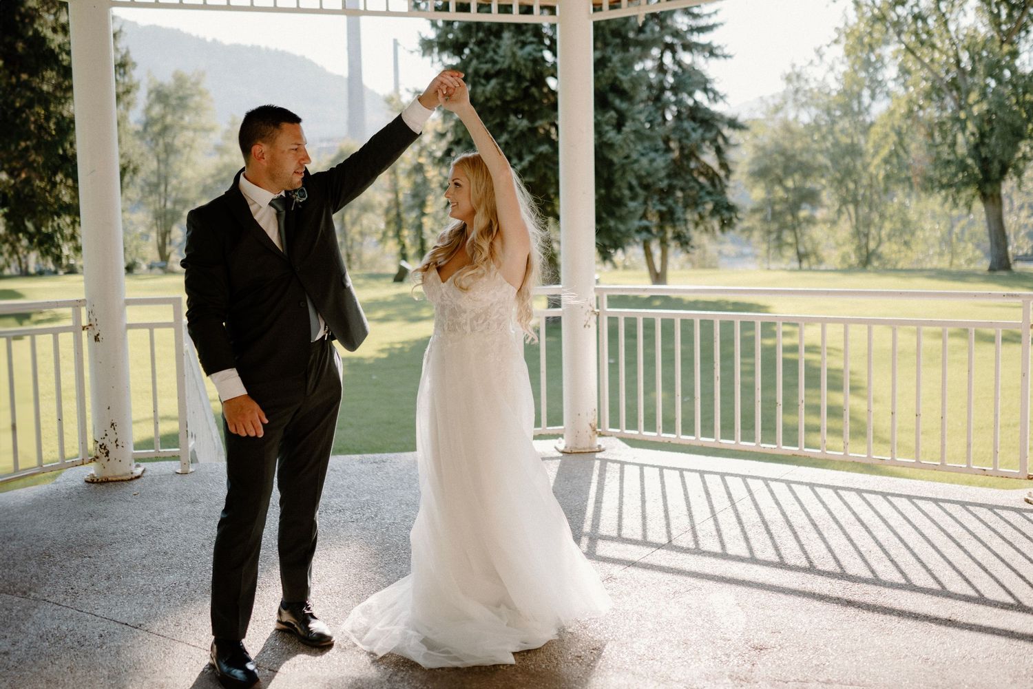 Bride and groom dancing in a covered patio