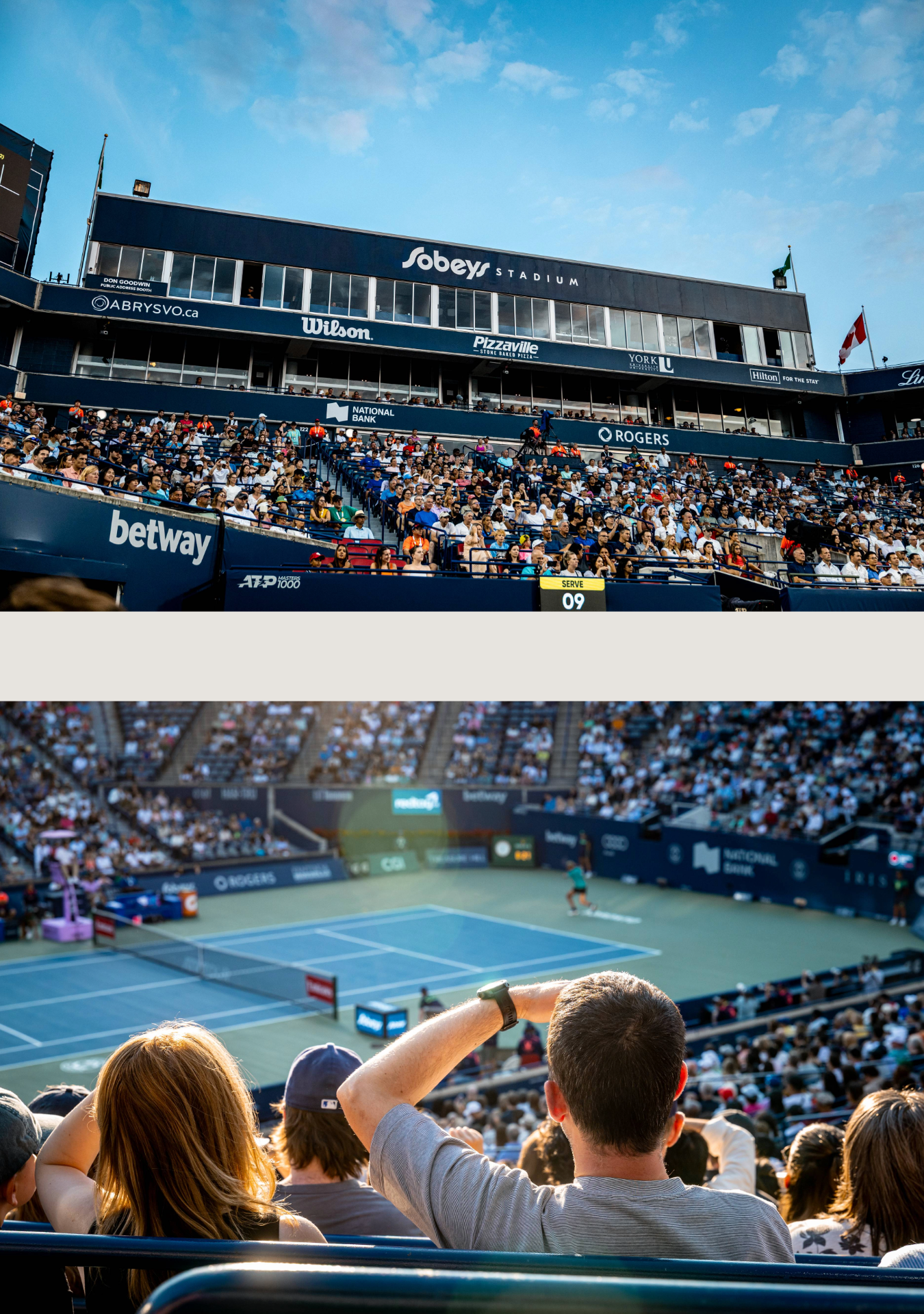 Crowded tennis stadium with spectators watching a match under bright blue skies.