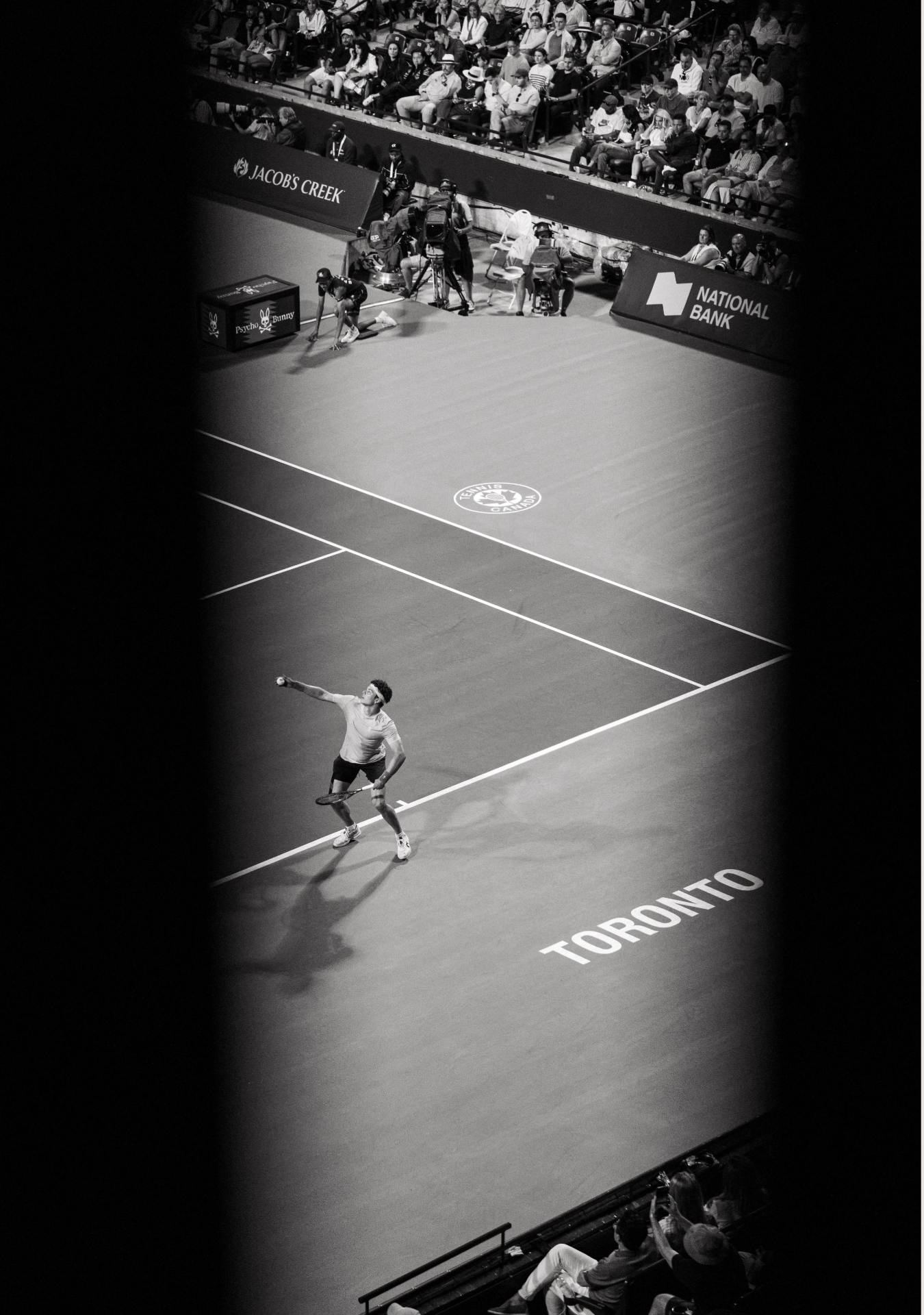 Professional tennis player serves during a competitive match on a hard court at a tournament in Toronto.