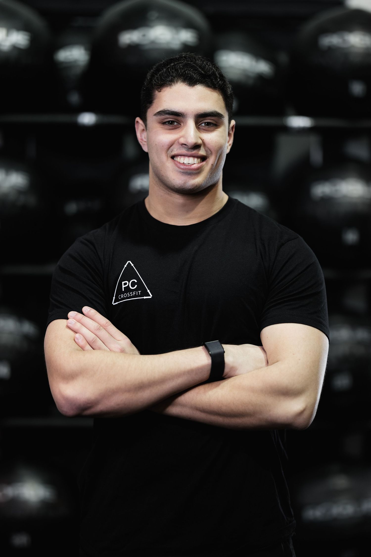 Athletic person in black t-shirt with PC logo posing against dark background in multiple shots.