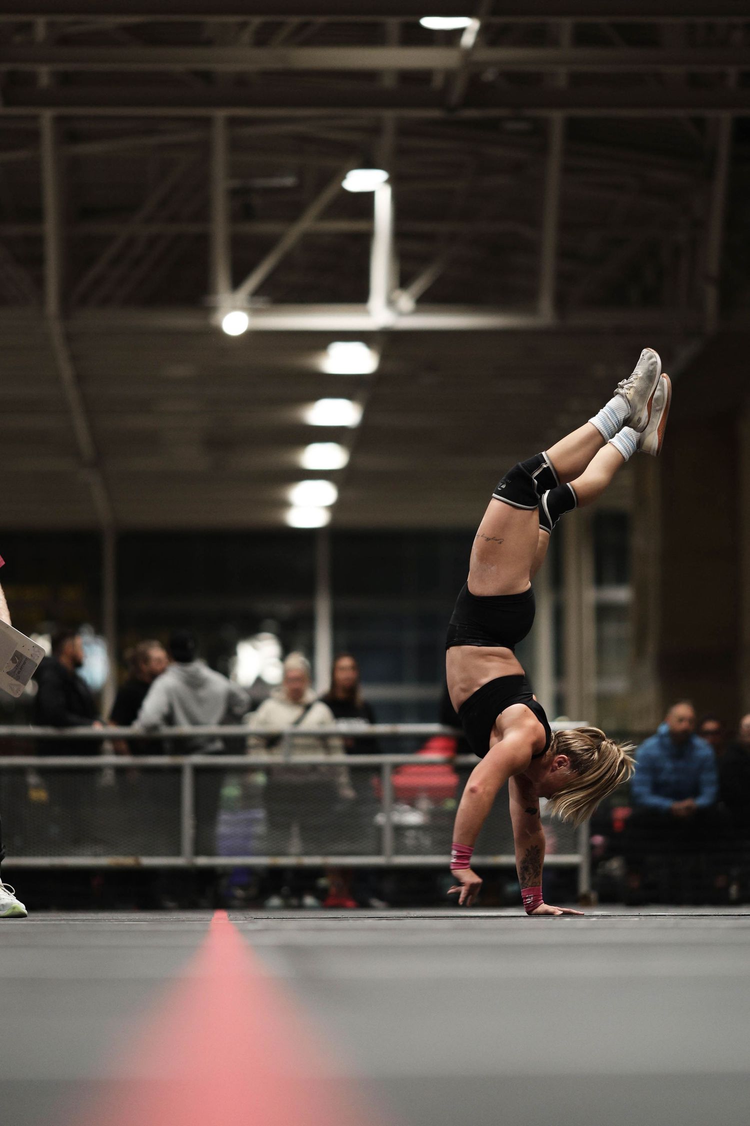 Progressive sequence showing a gymnast performing a back handspring on a training mat in a gymnastics facility.