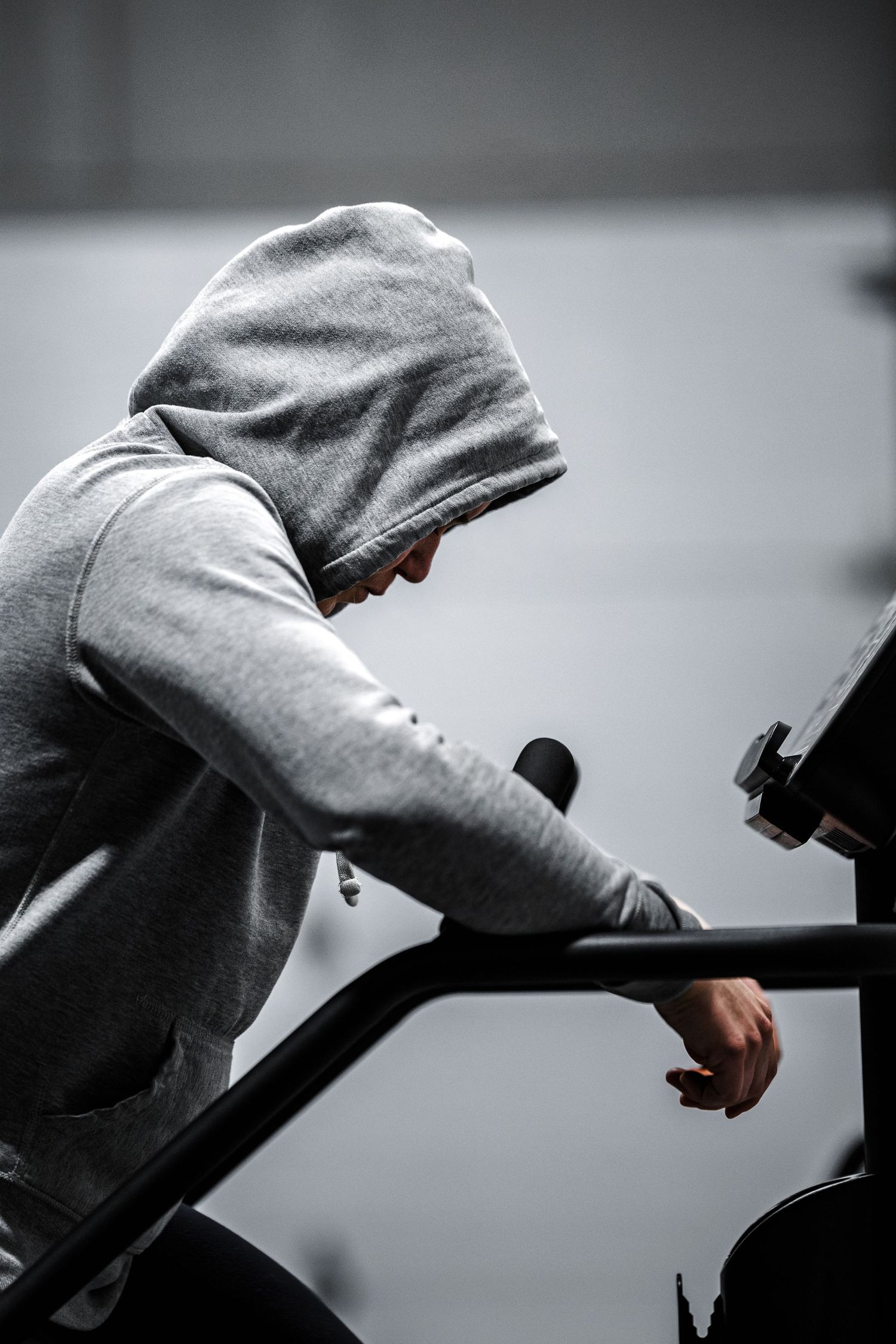 A series of black and white photos showing a person in a gray hoodie holding a handgun in threatening positions.