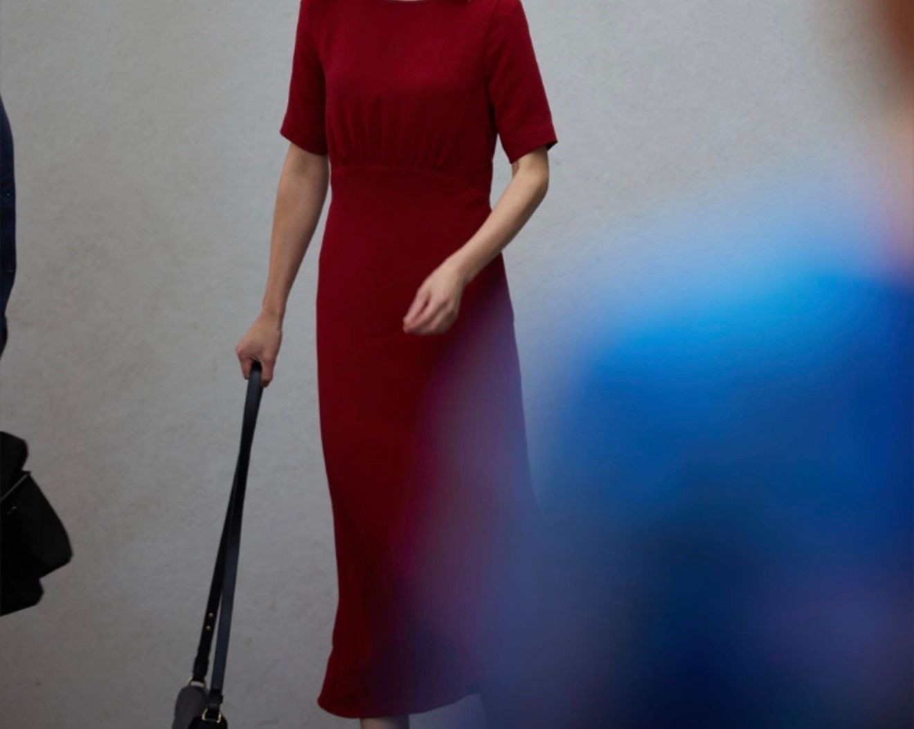 Woman in red dress holding a bag