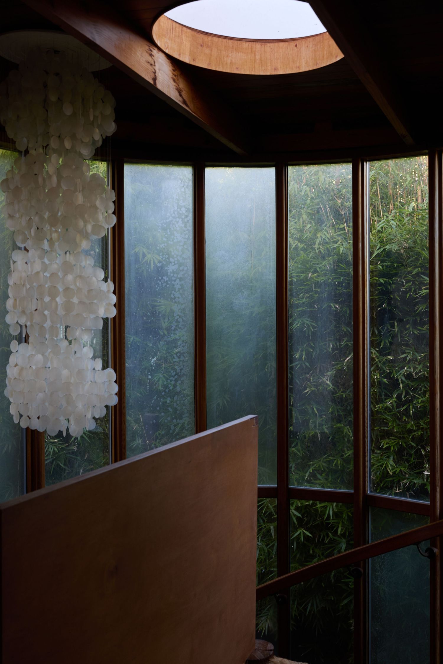 Interior with long windows, round skylight and chandelier