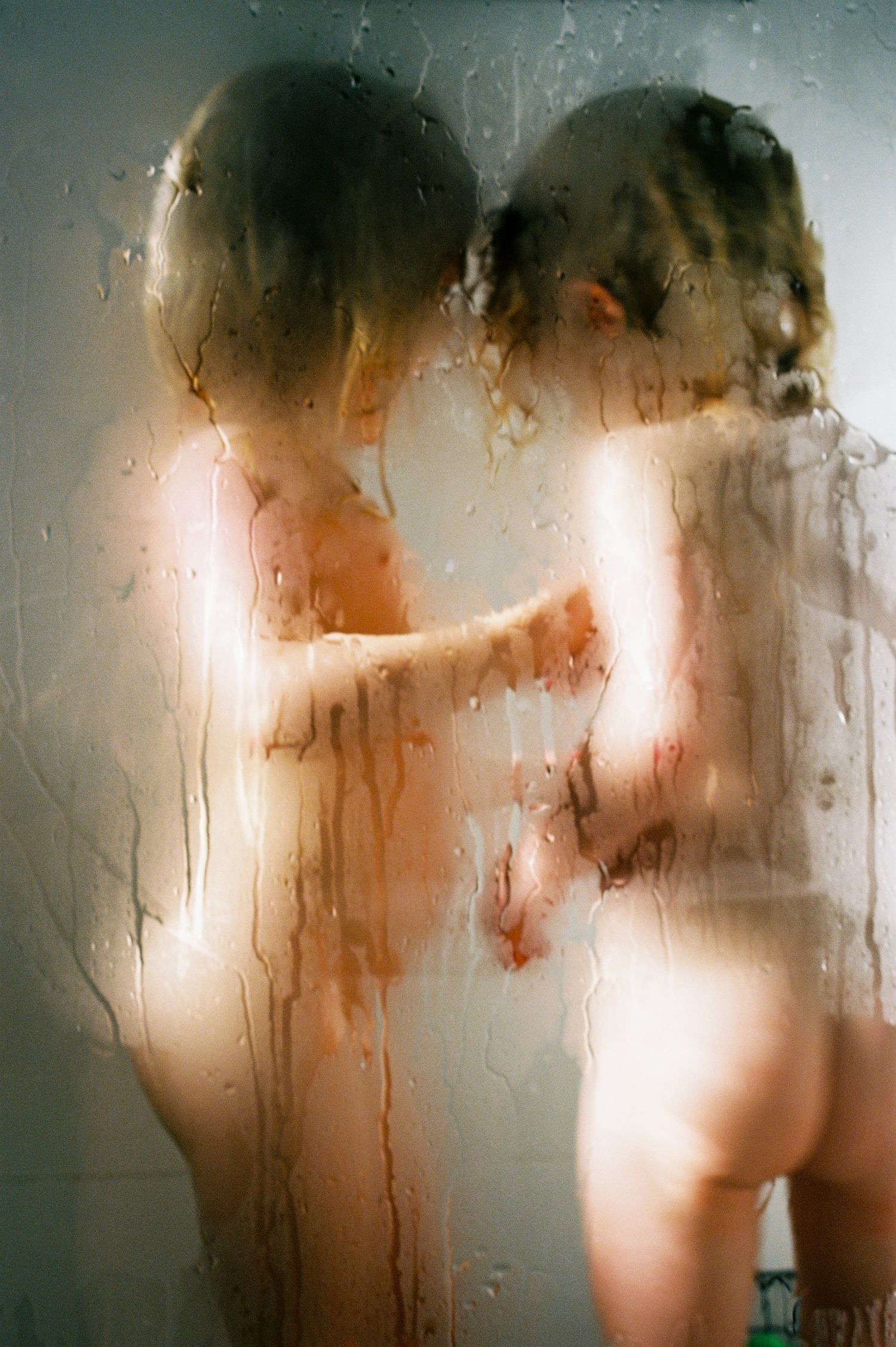 Two young kids in the shower