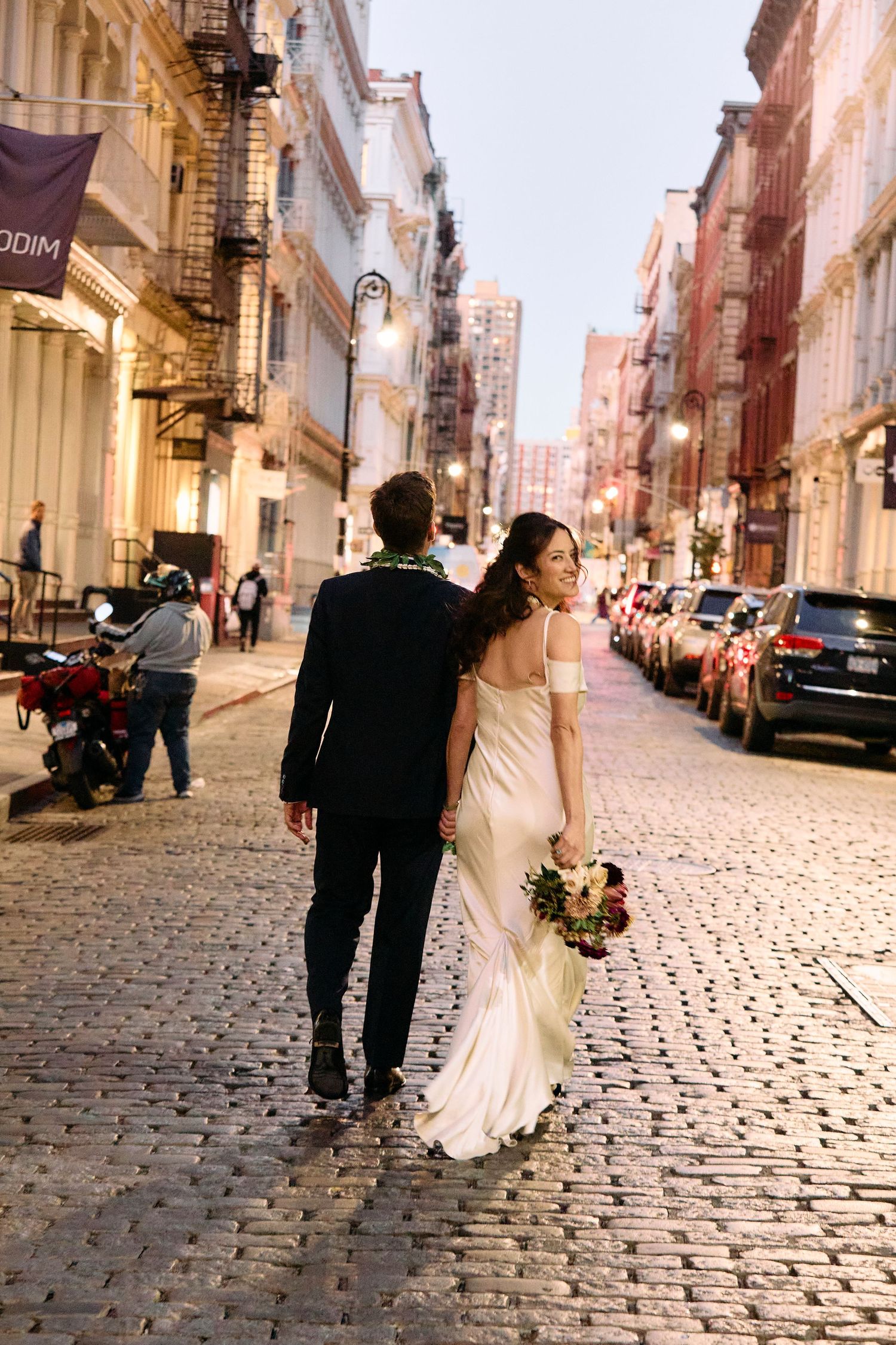 Bride and groom walking cobbled streets