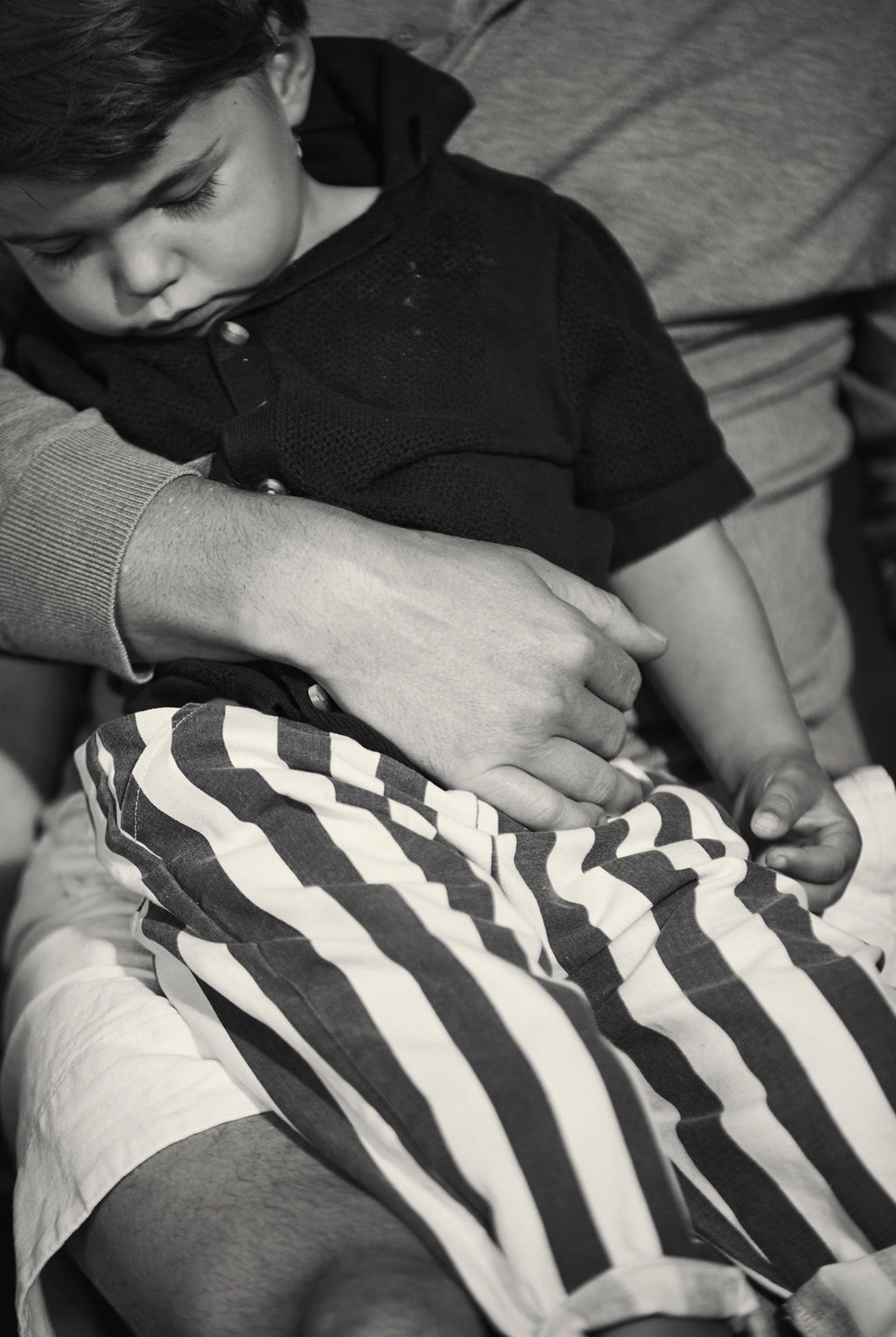 Child asleep on lap black & white