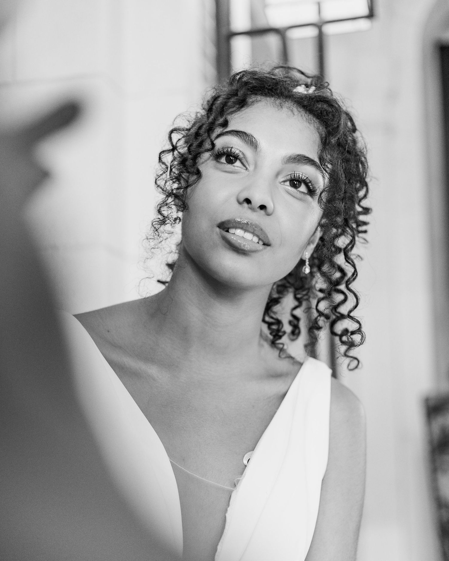 Artistic black and white bridal portraits showing elegant styling and natural curls.