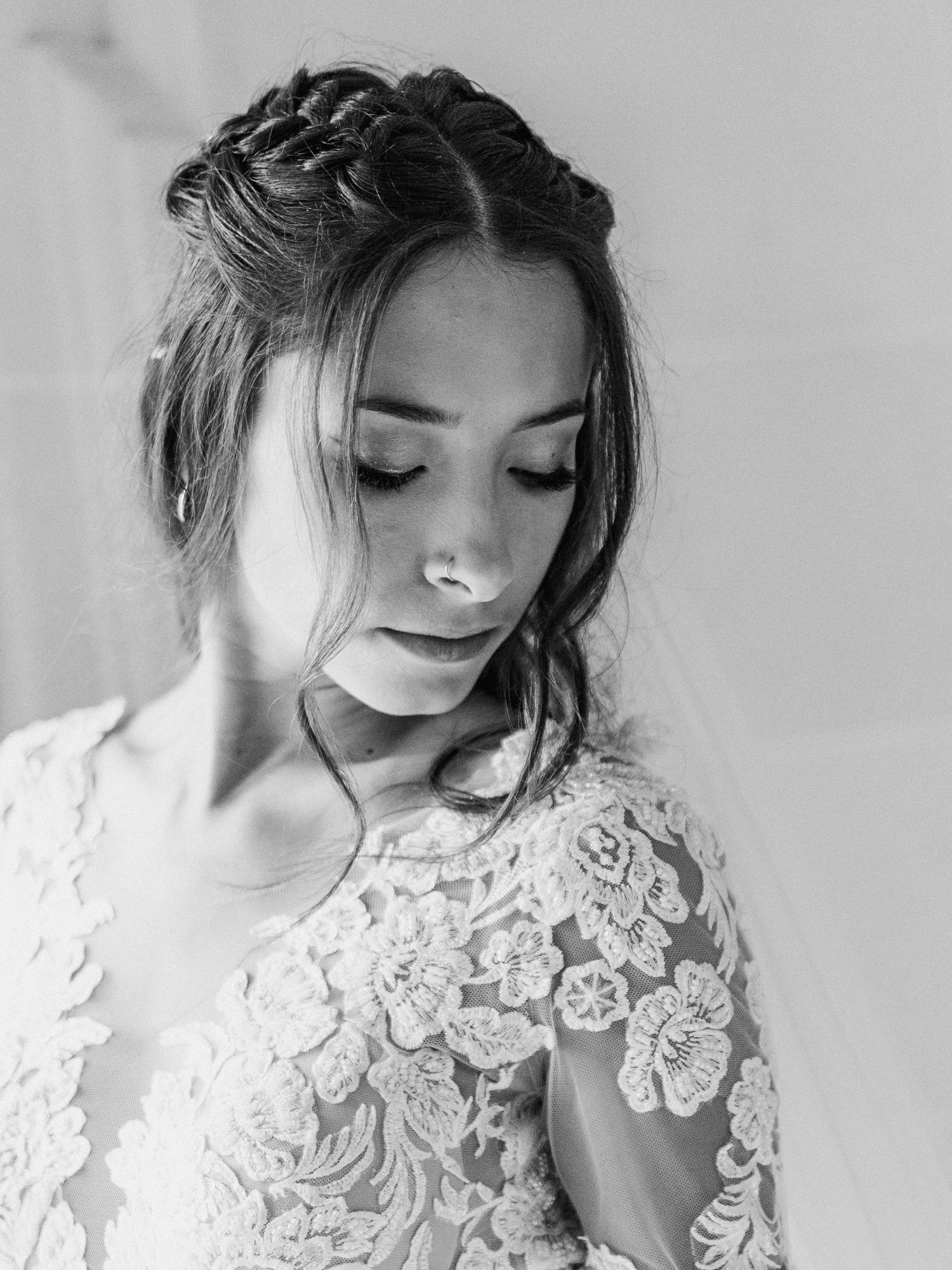 Close-up detail of intricate white lace appliques on a wedding dress bodice.