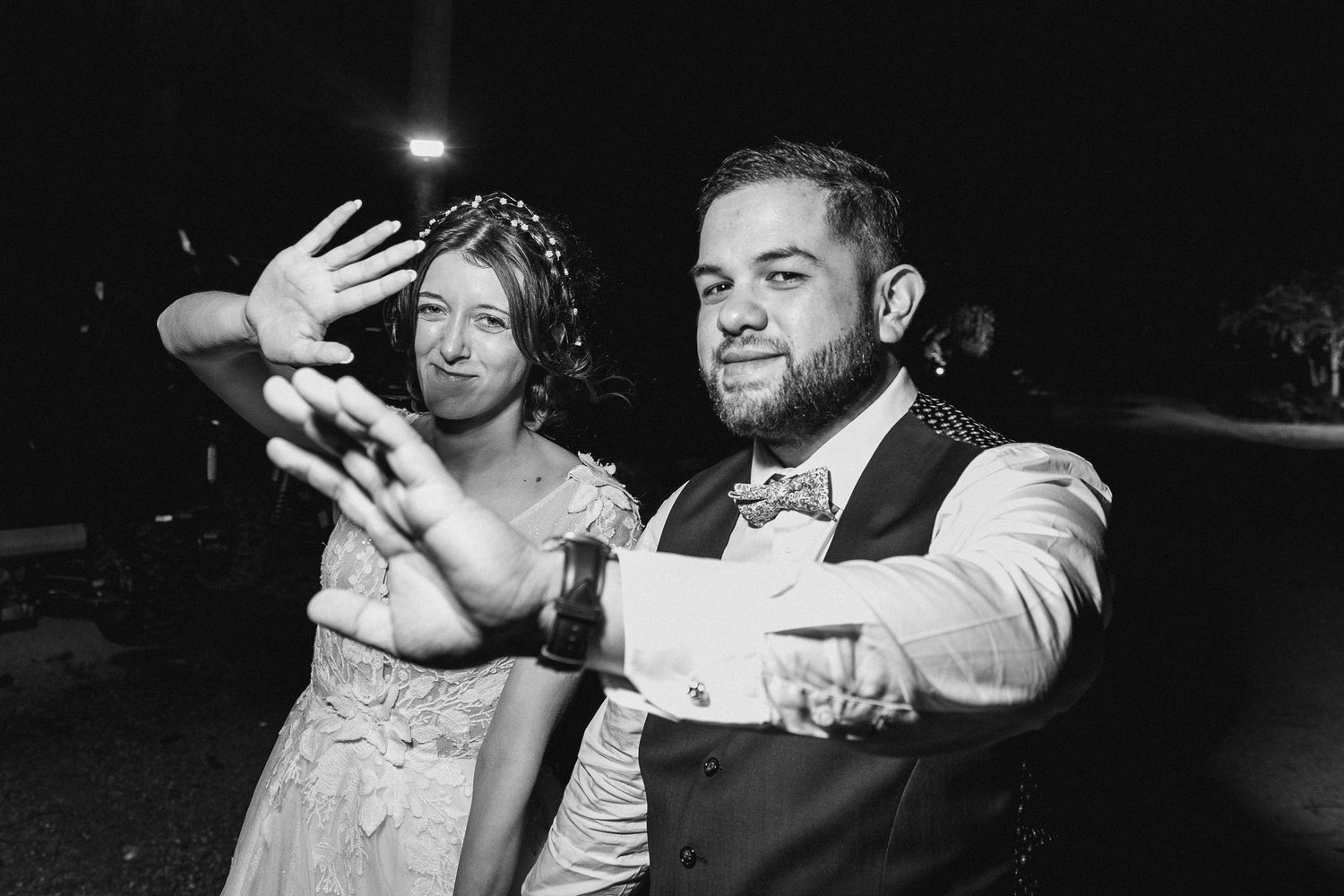 Black and white photo of wedding celebration with guests showing excitement.