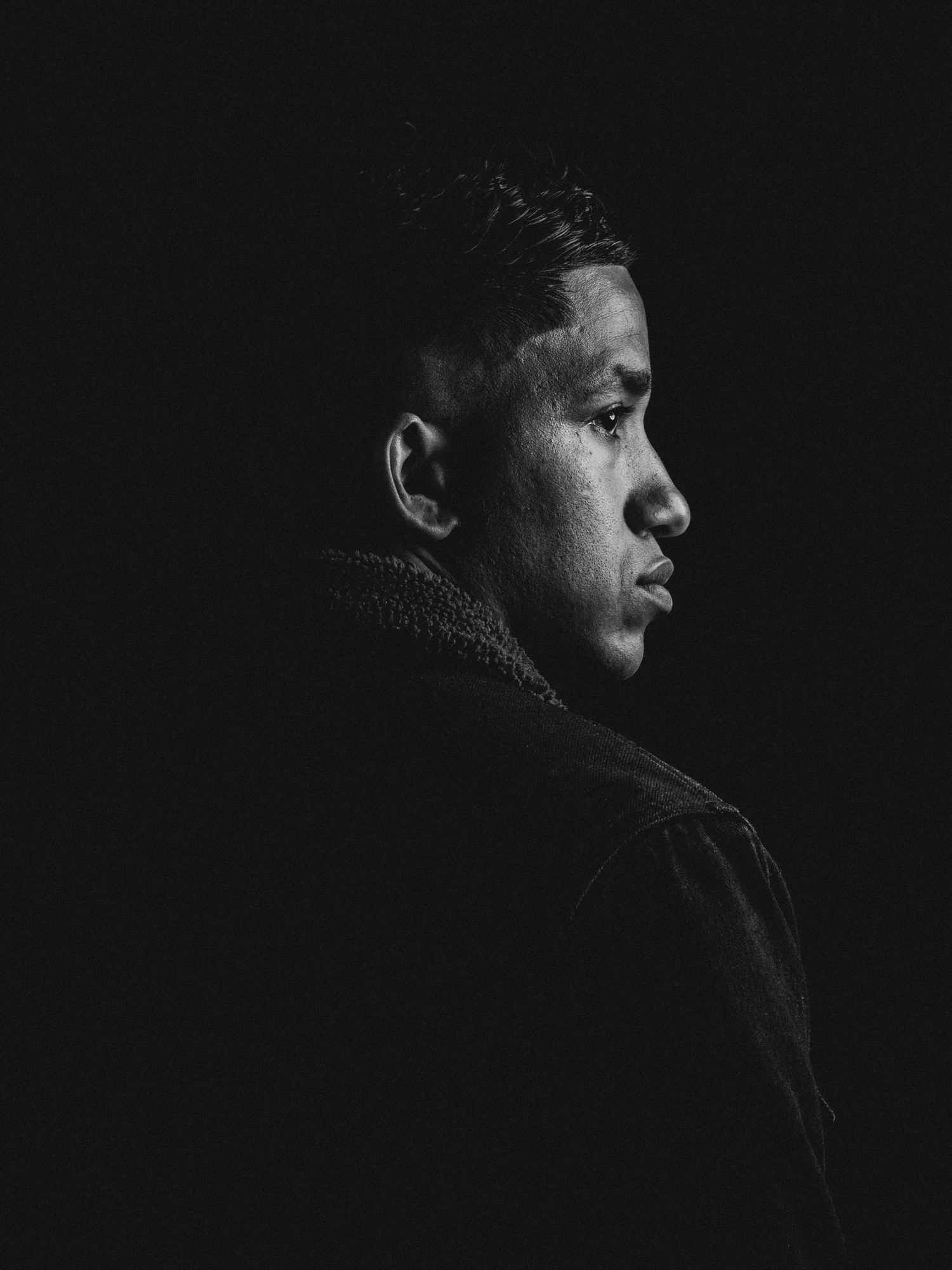 Dramatic black and white profile silhouette sequence against dark background.