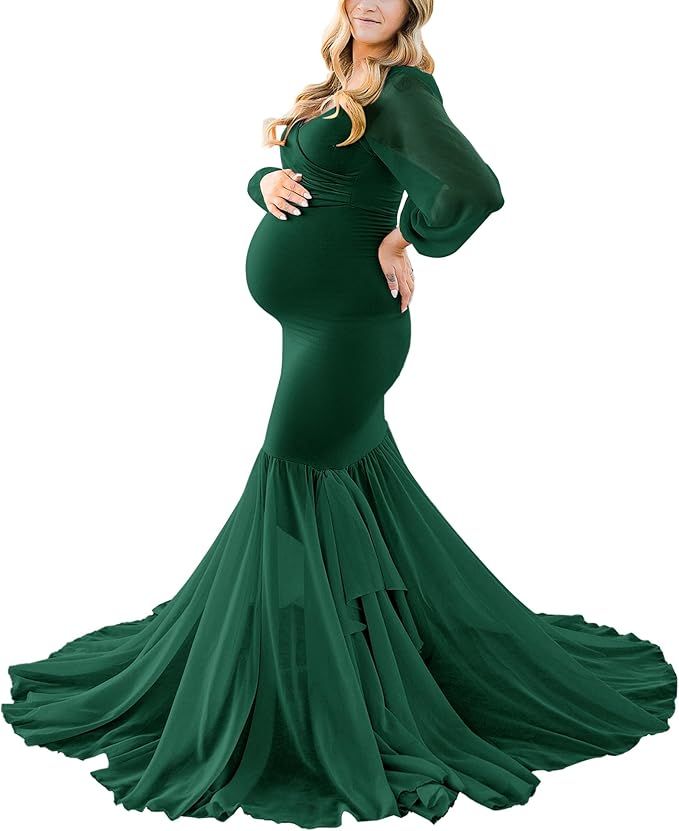 Emerald green maternity dress with fitted bodice and dramatic flared skirt for photography.