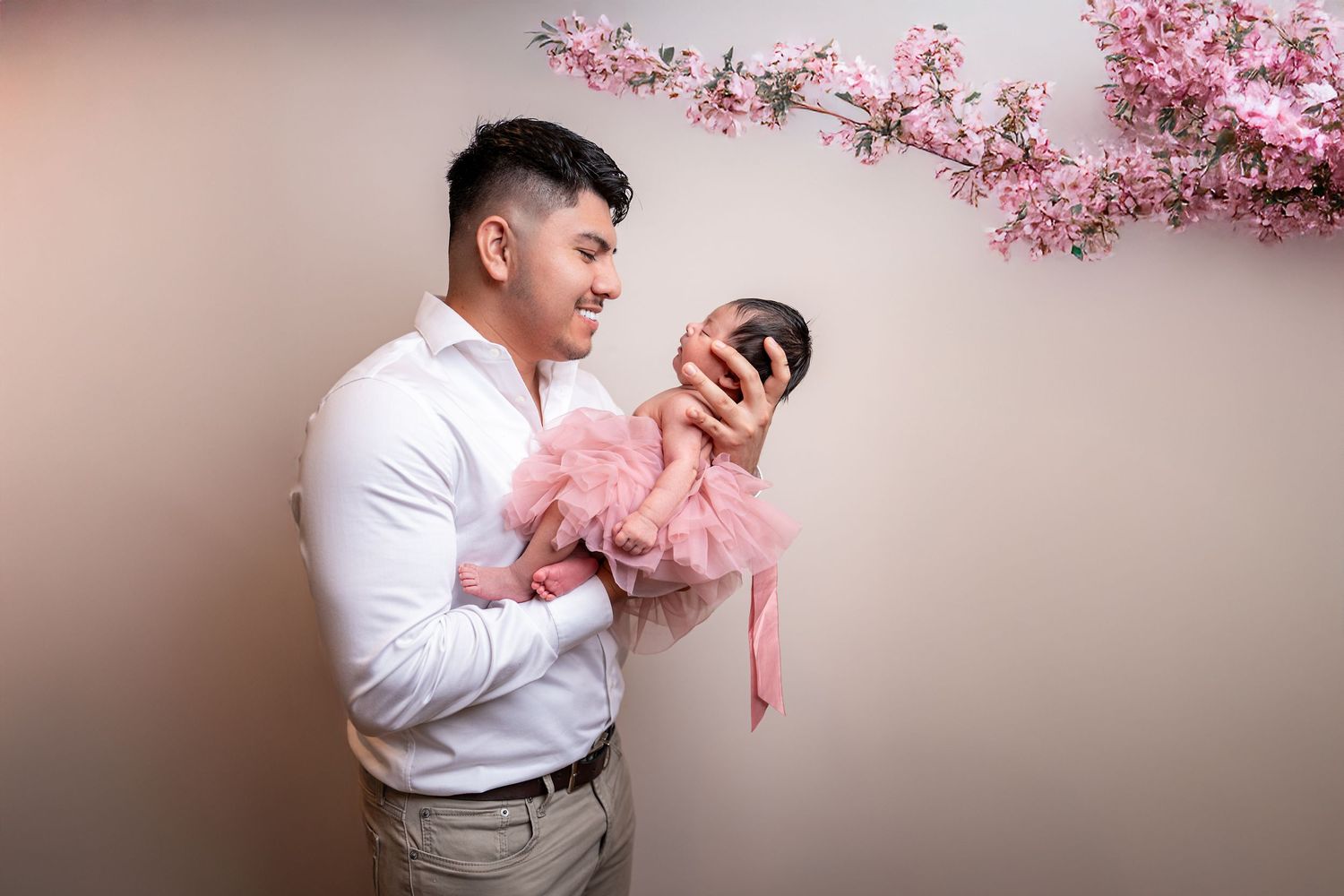 A tender moment captured with cherry blossoms in the background.