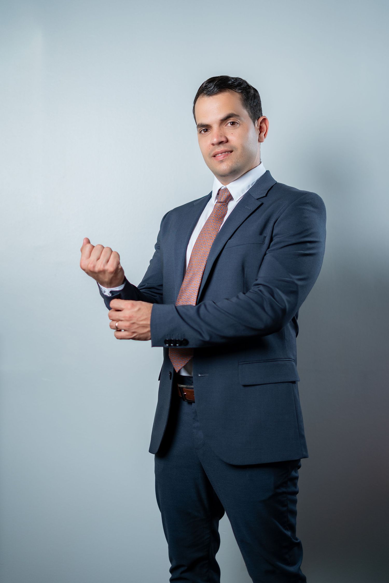 Professional in navy suit demonstrates different poses against gray background in sequence of connected photos.