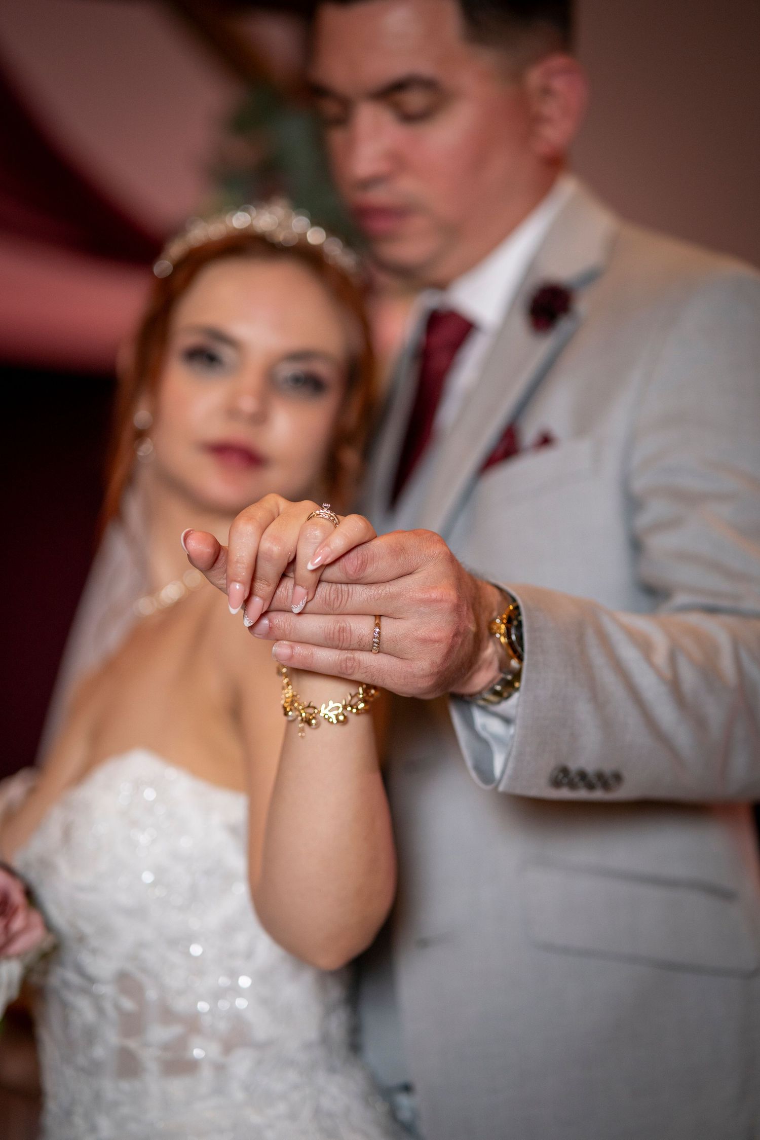 Close-up sequence showing hands exchanging wedding rings during an intimate ceremony.