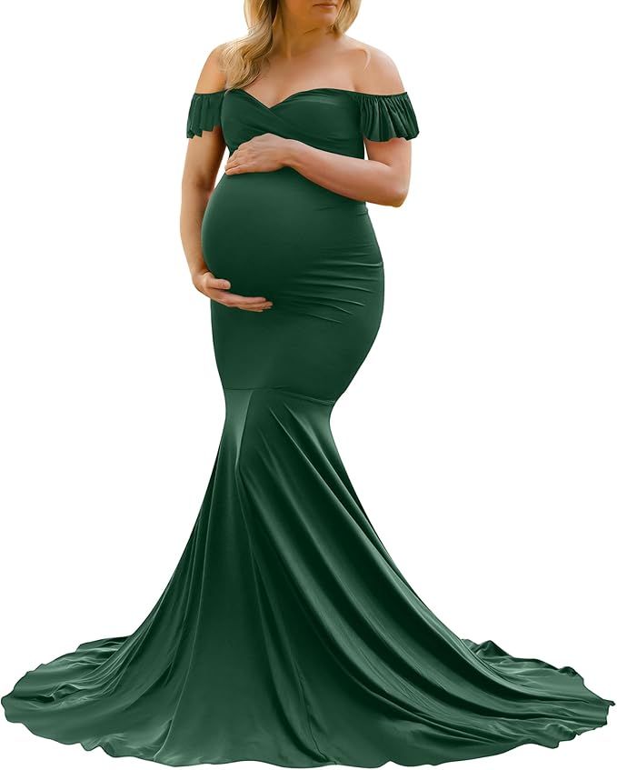 Off-shoulder emerald green maternity dress with ruffle neckline and dramatic mermaid-style sweep train.
