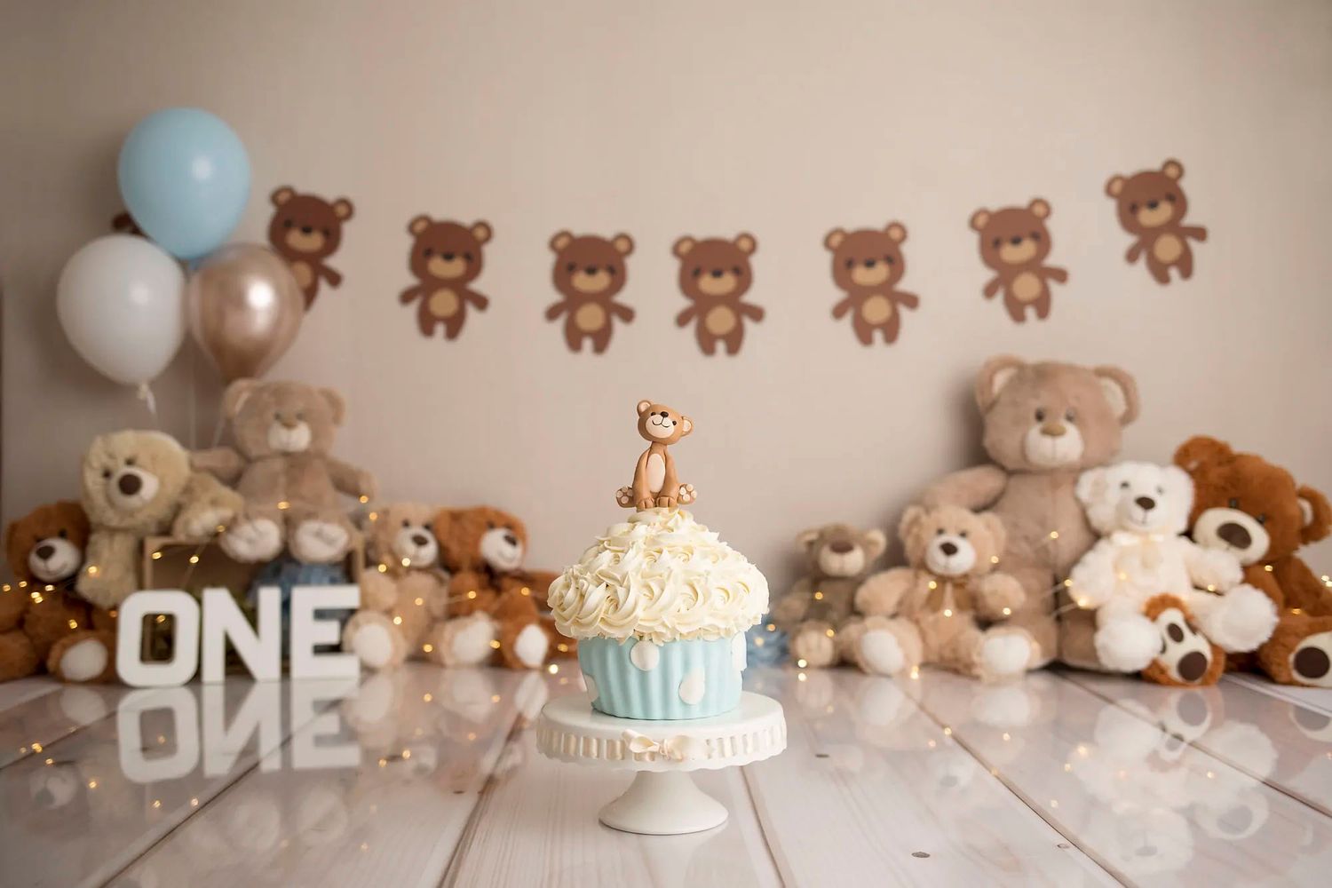 A row of teddy bears arranged on a white shelf with soft lighting and neutral tones creating a cozy nursery display.