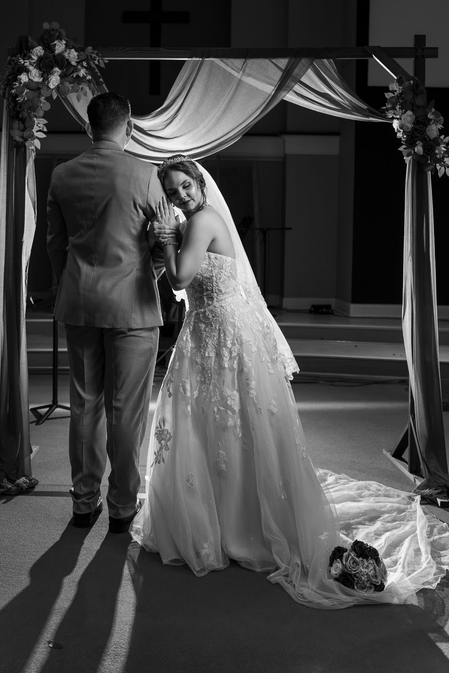 Black and white wedding photos showing intimate dance moments with dramatic lighting and flowing bridal gown.