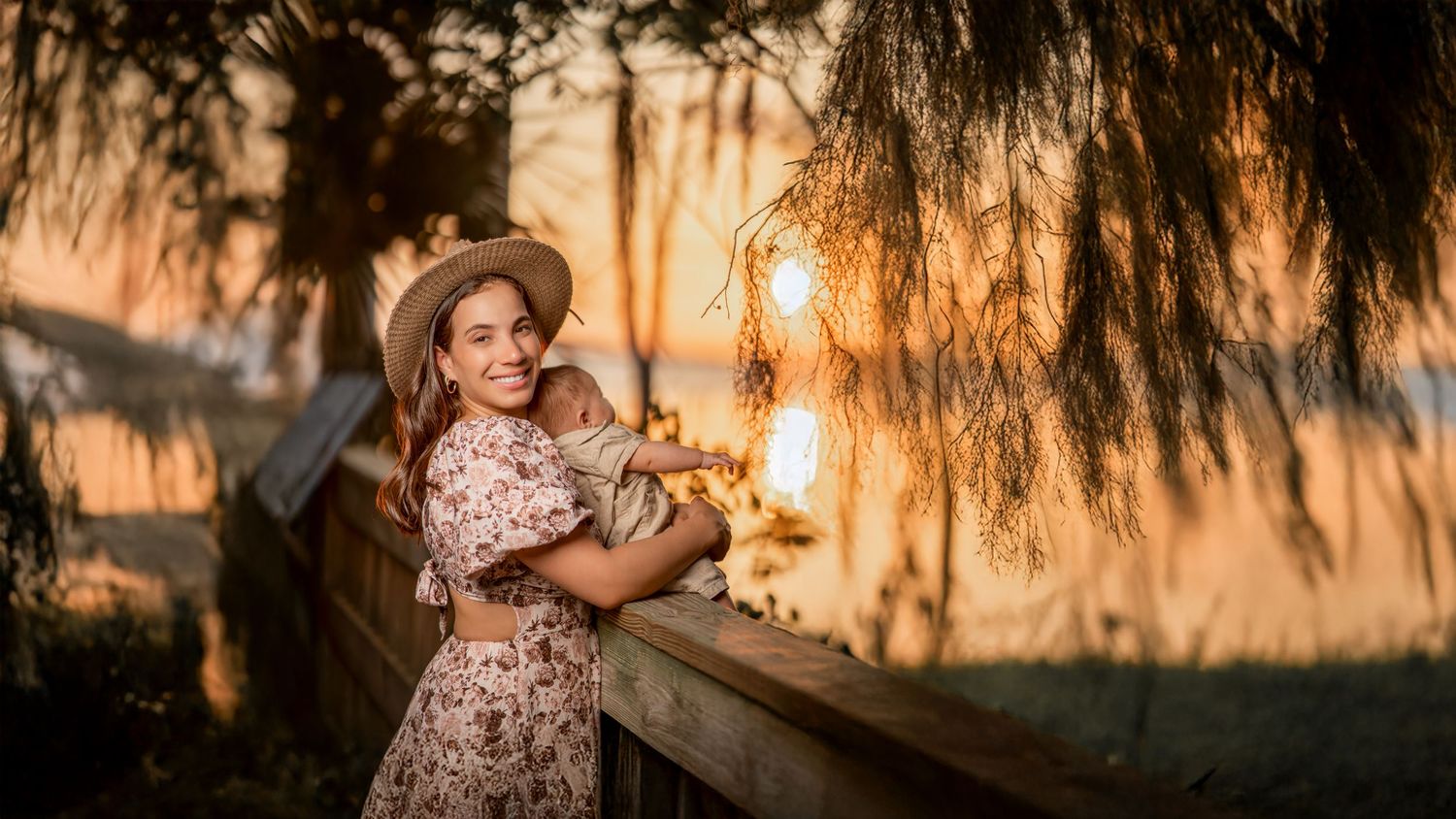 Portrait session at sunset with willow trees creating dreamy golden atmosphere.