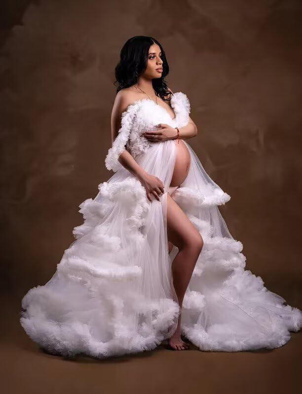 Artistic maternity boudoir photo series in white tulle gown against dark background showing graceful poses.