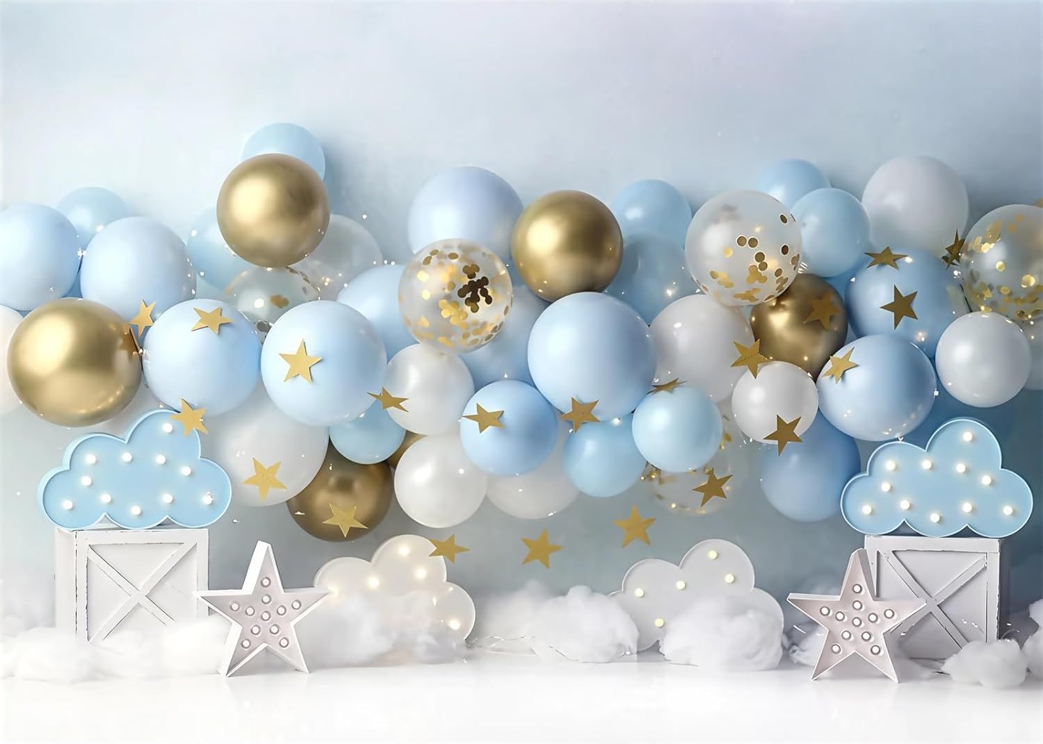 Light blue and gold balloon garland with cloud and star decorations against a white wall.