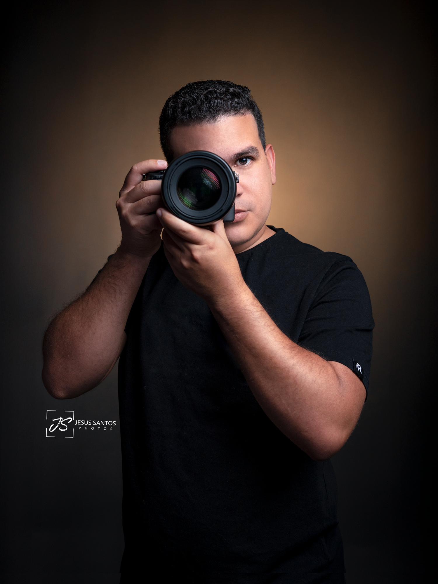 Photographer in dark clothing holds camera in various poses against dark background creating dramatic silhouettes.