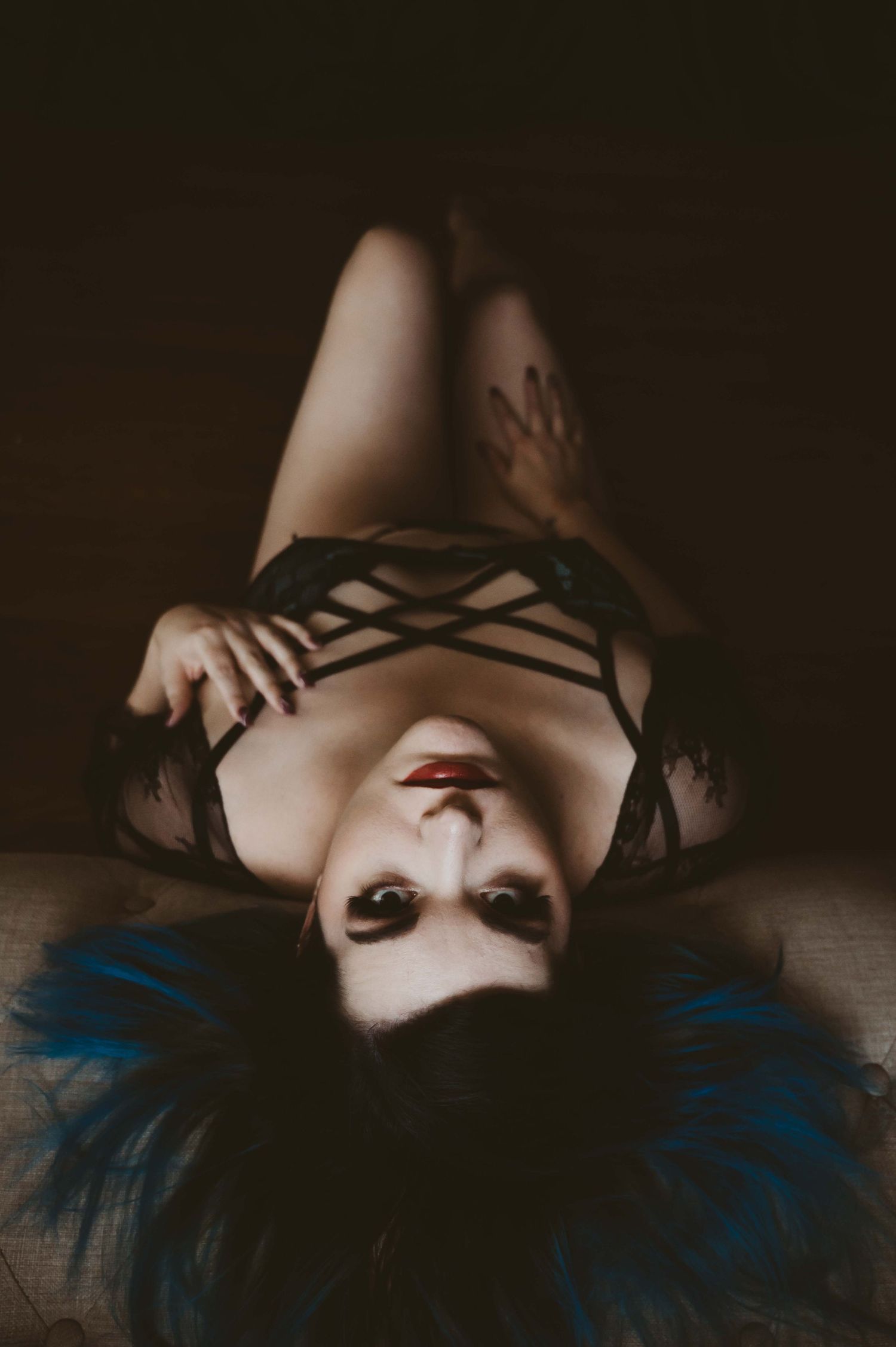 Moody boudoir portrait – woman with blue hair in black lingerie, bold and confident