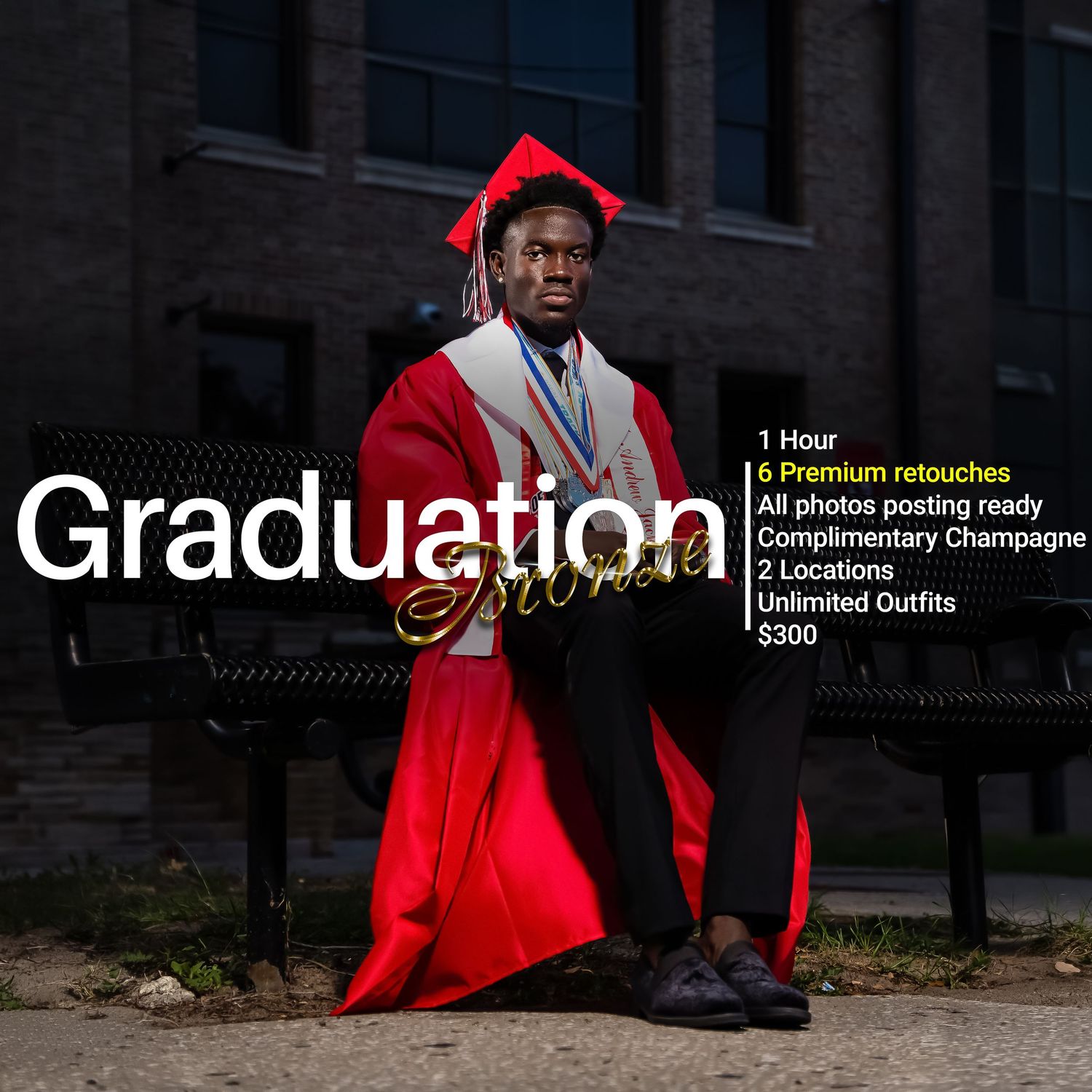 Graduate in bright red cap and gown poses confidently against brick building during graduation photo session.