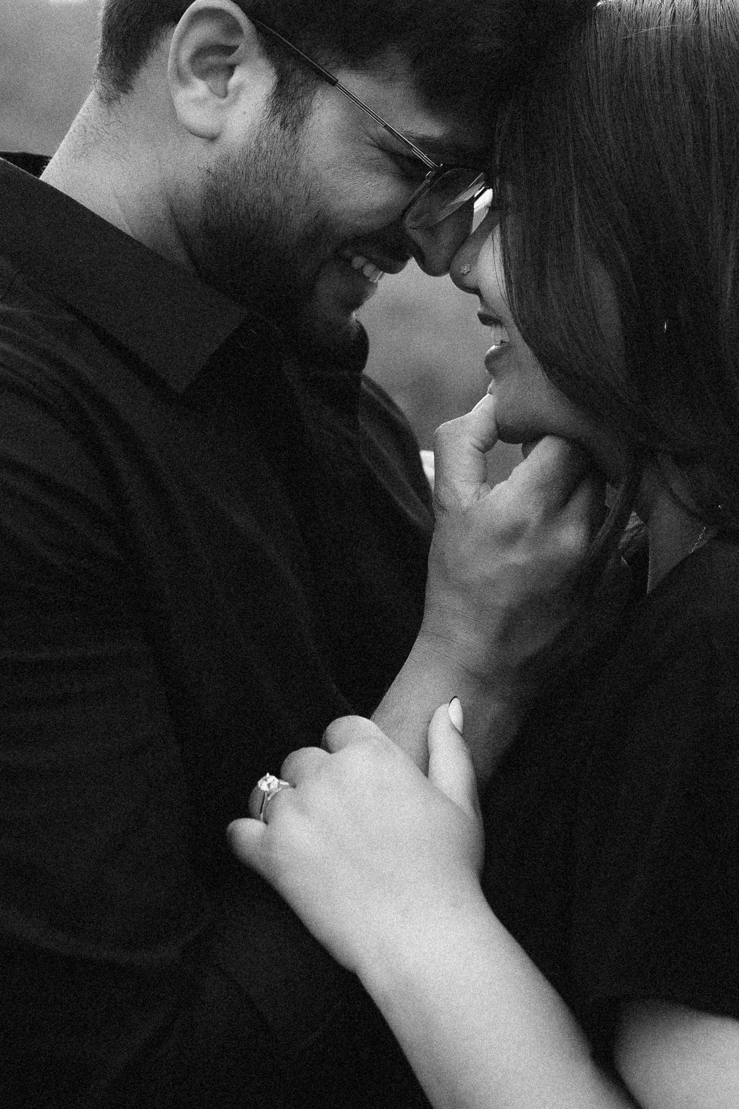 A romantic black and white photo sequence showing a couple in an intimate embrace and kiss.