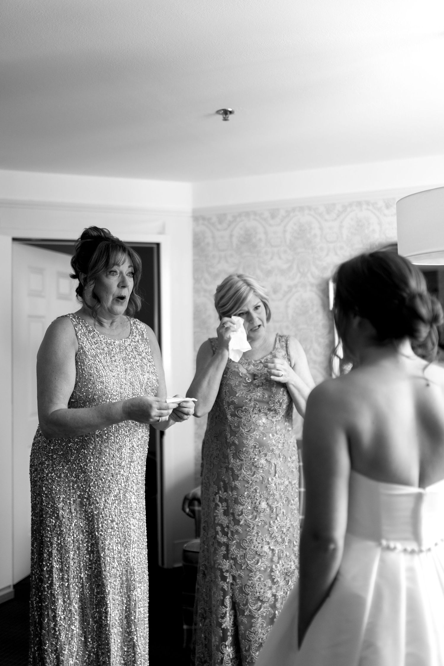 A sequence of black and white photos showing a sparkly formal dress being fitted and adjusted.