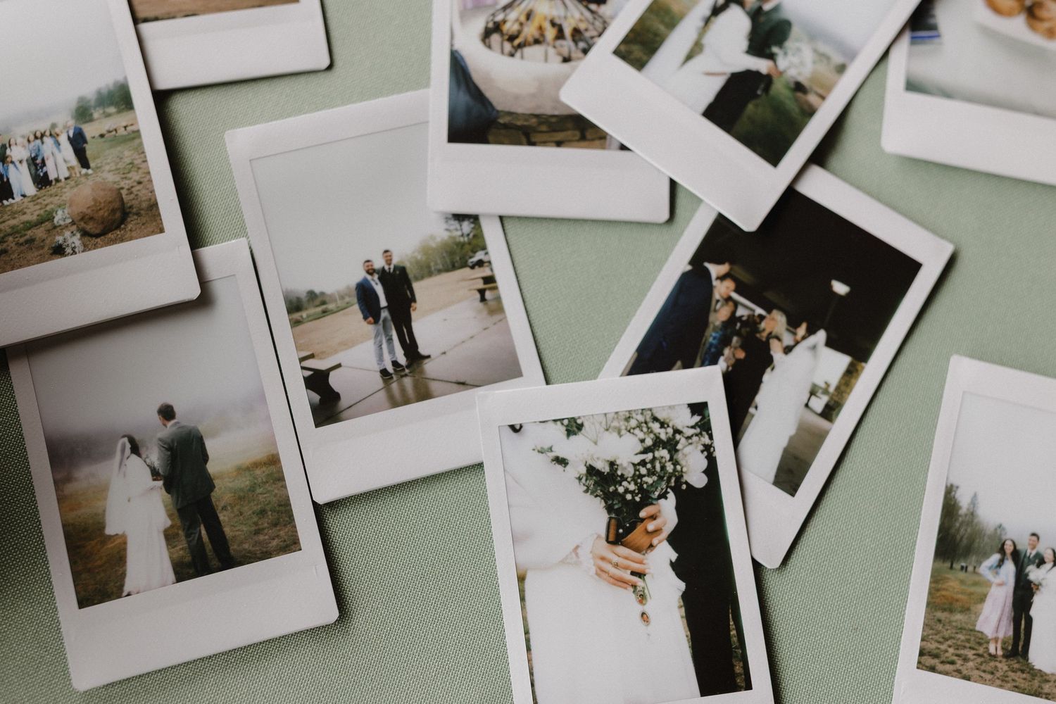 Collection of vintage-style polaroid wedding photographs scattered on mint green background.