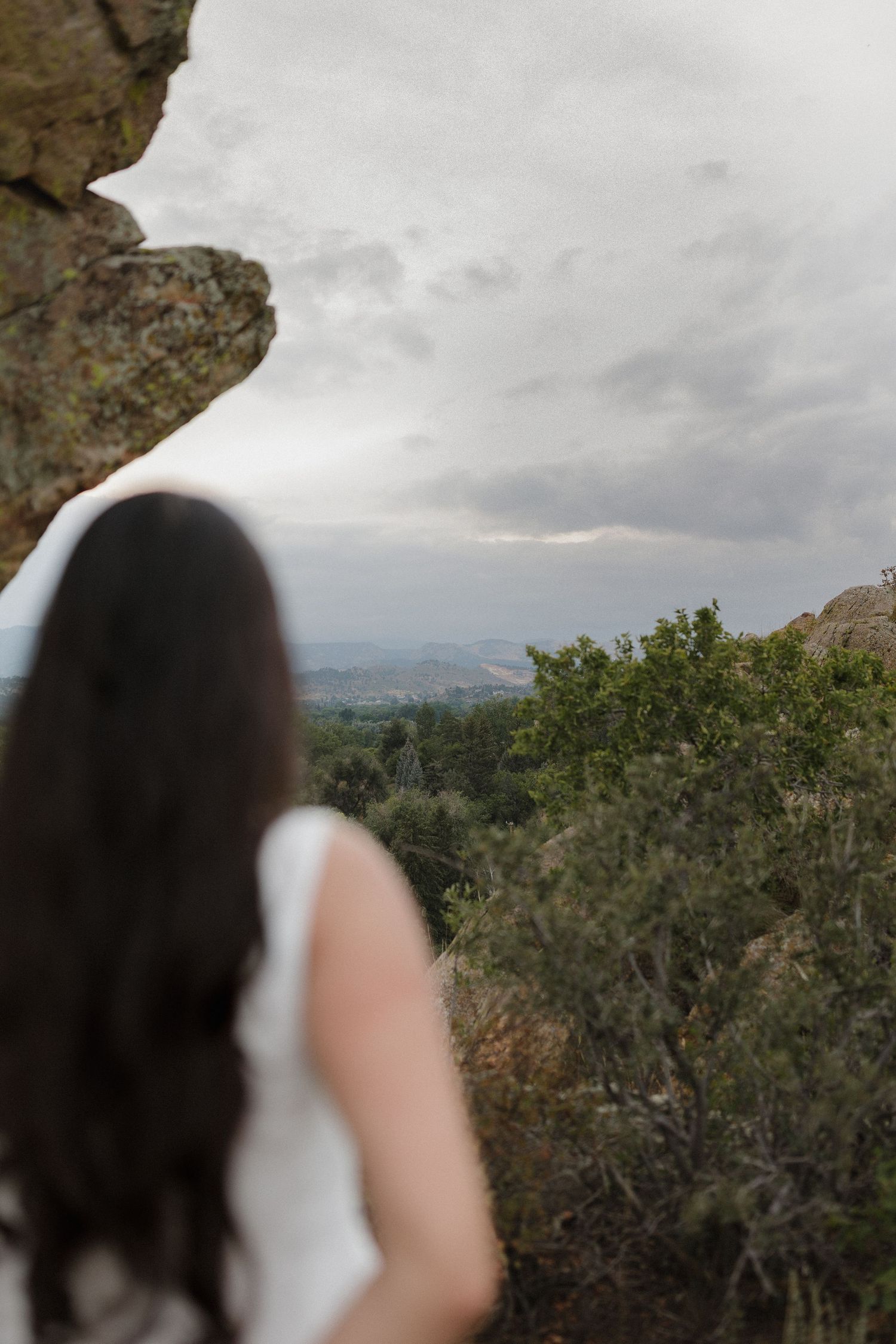A panoramic sequence shows blurred figures against a cloudy mountain landscape with green foliage and rocky terrain.