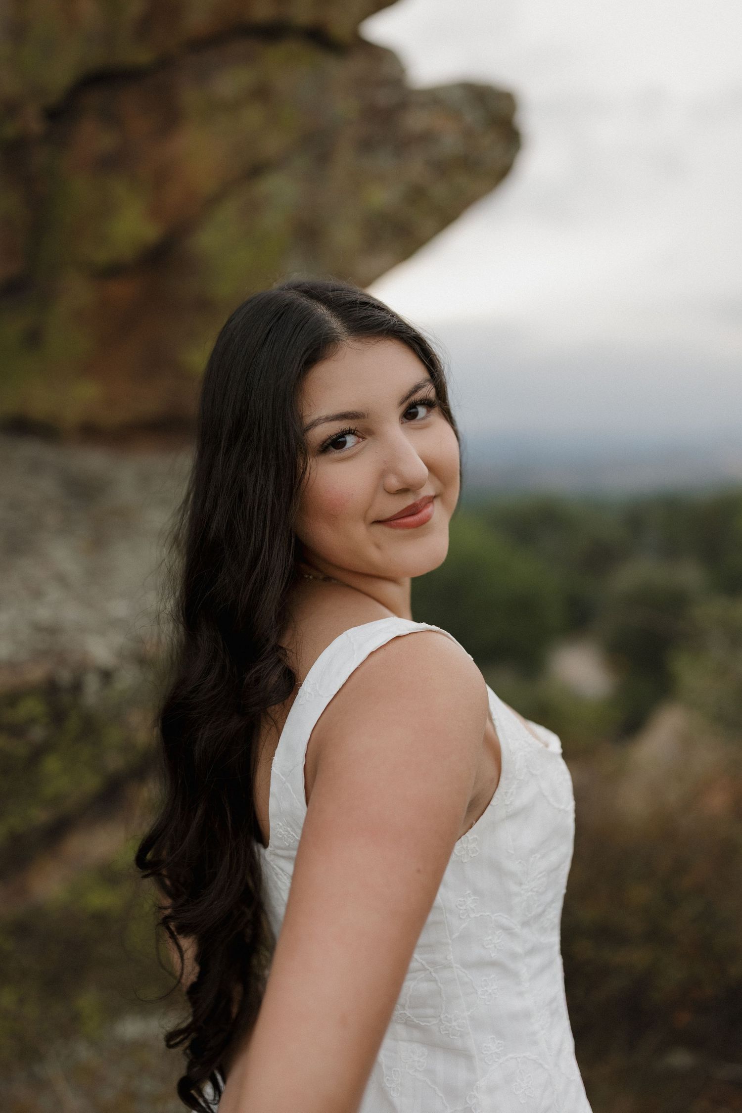 A series of romantic outdoor portrait photos showing someone in a white sleeveless dress against a nature backdrop.