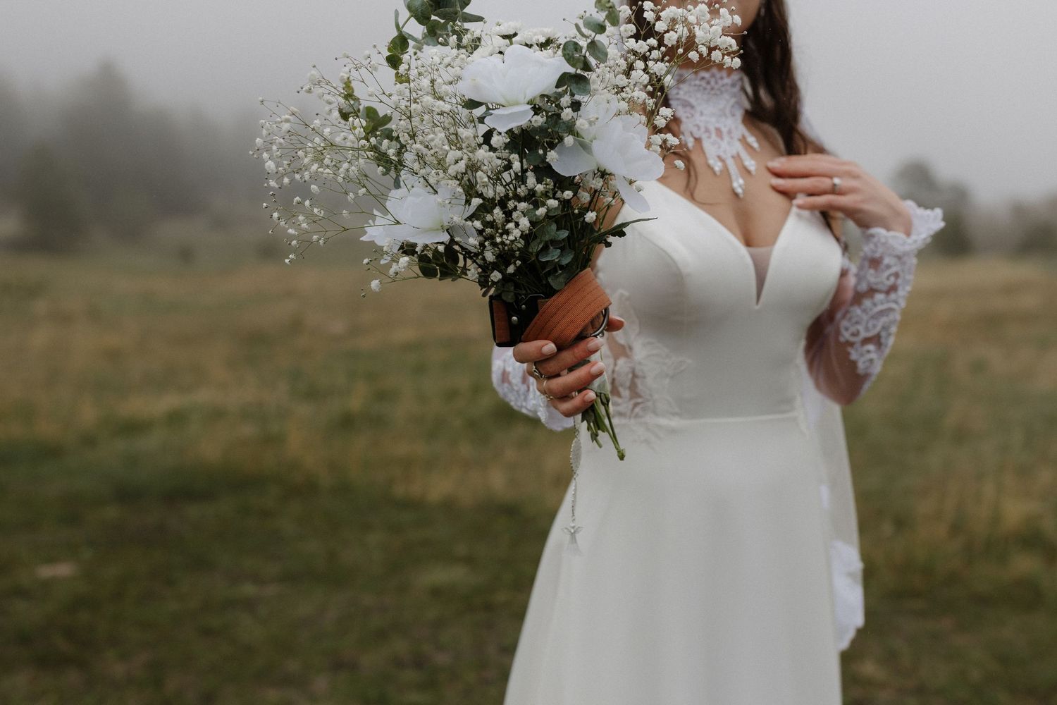 A collection of six wedding photos showing the bride's white lace dress details in an outdoor rustic setting.