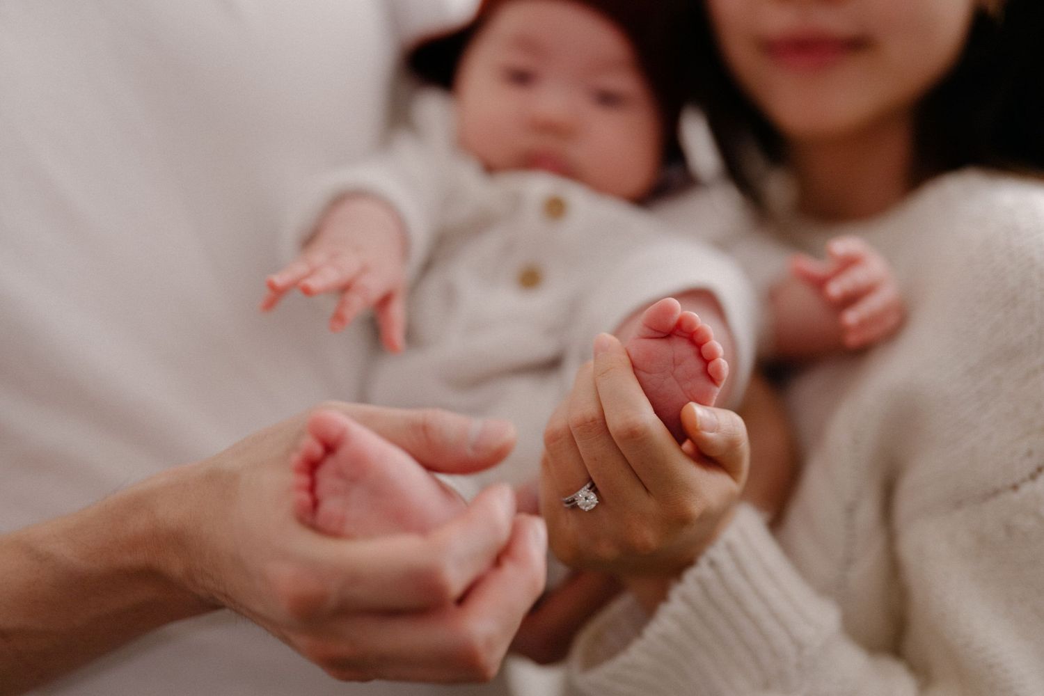 Close-up shot of gentle hands touching and connecting in soft natural light.