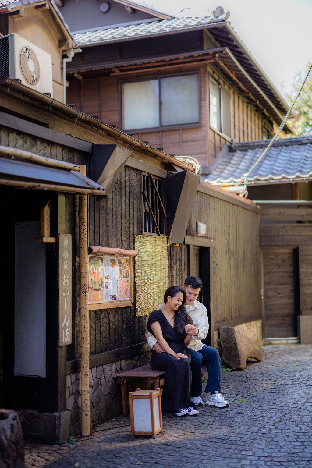 A peaceful moment outside a traditional Japanese house with wooden architecture and tiled roof.