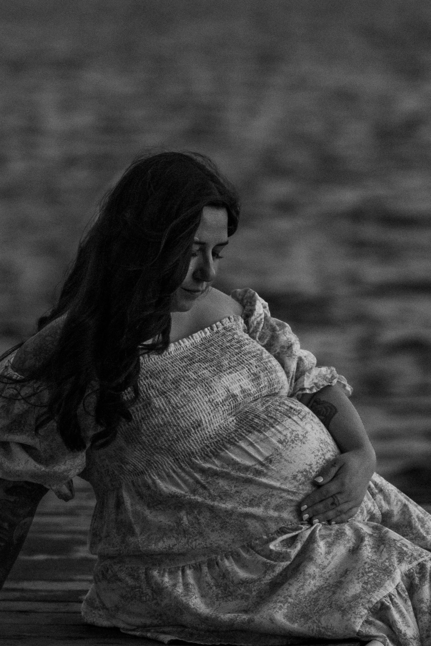 A series of black and white photos showing a person in a flowing white dress laying down in dramatic poses.