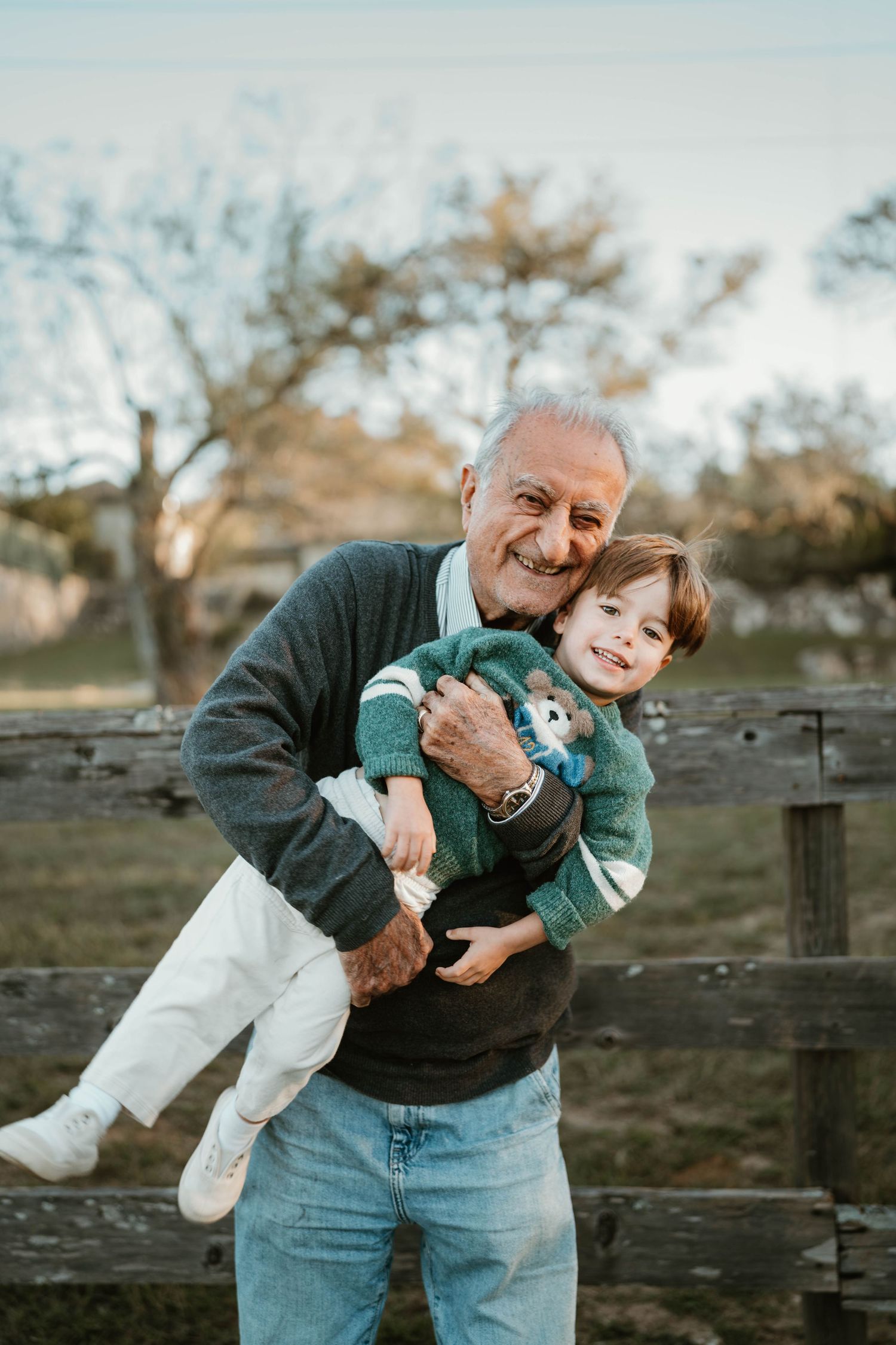 A playful sequence of outdoor photos showing a tender moment between two people against a rustic wooden fence at sunset.