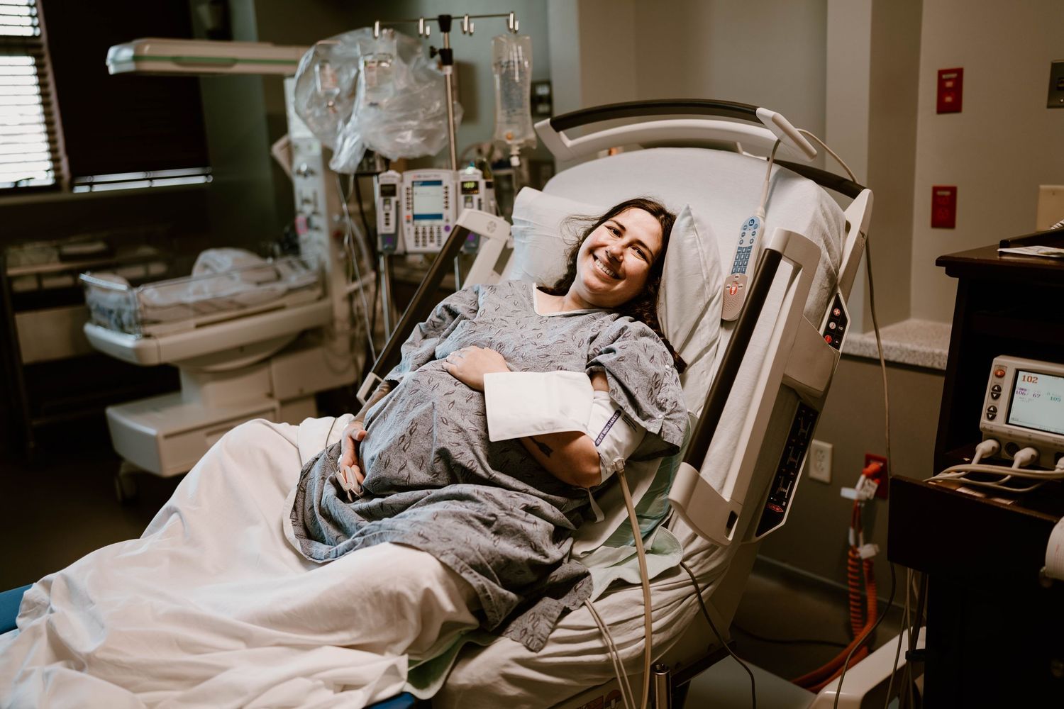 Patient lying on a medical examination table while receiving treatment in a healthcare facility.