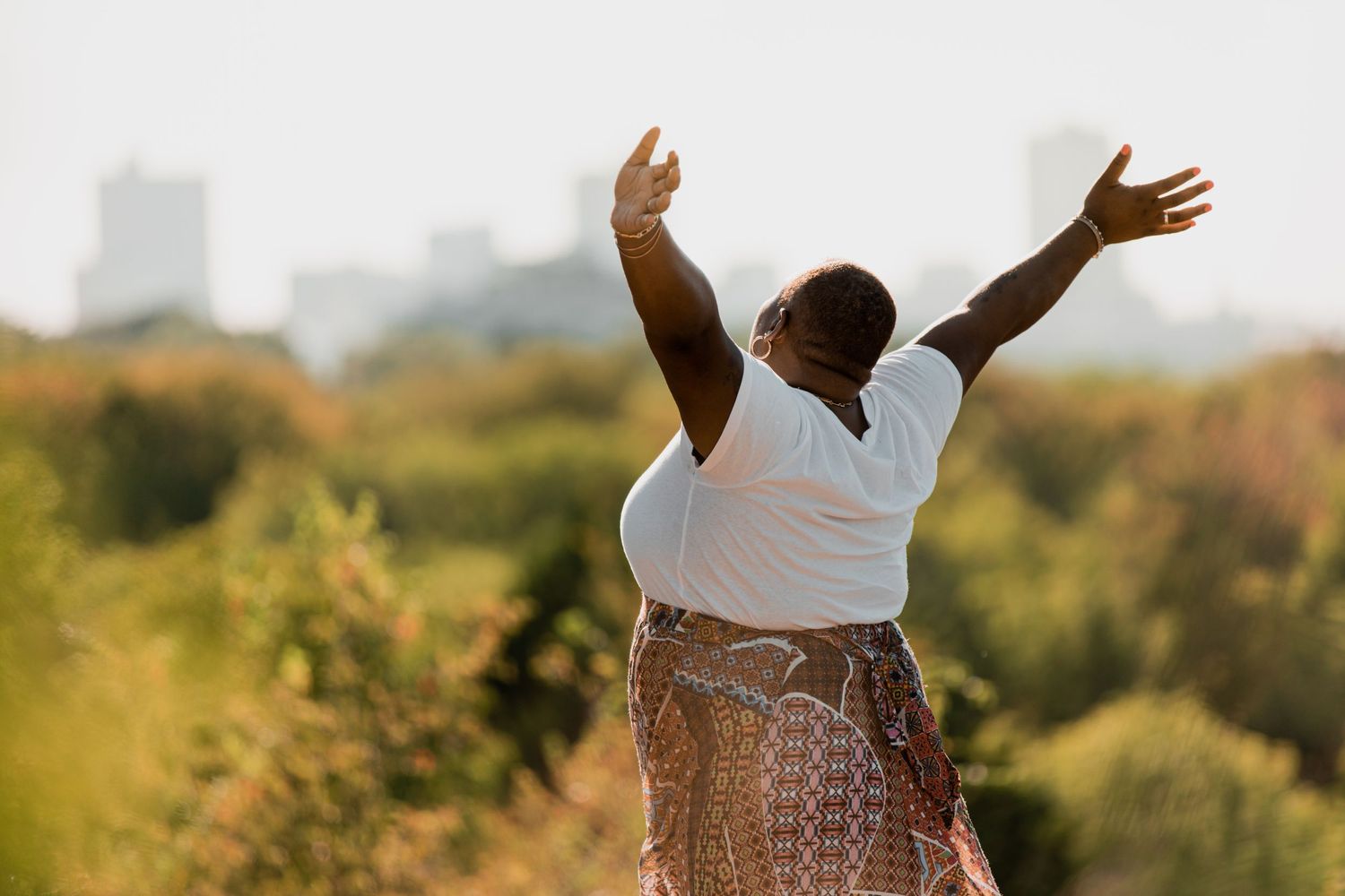 Expressive dance poses captured against a bright natural outdoor setting.