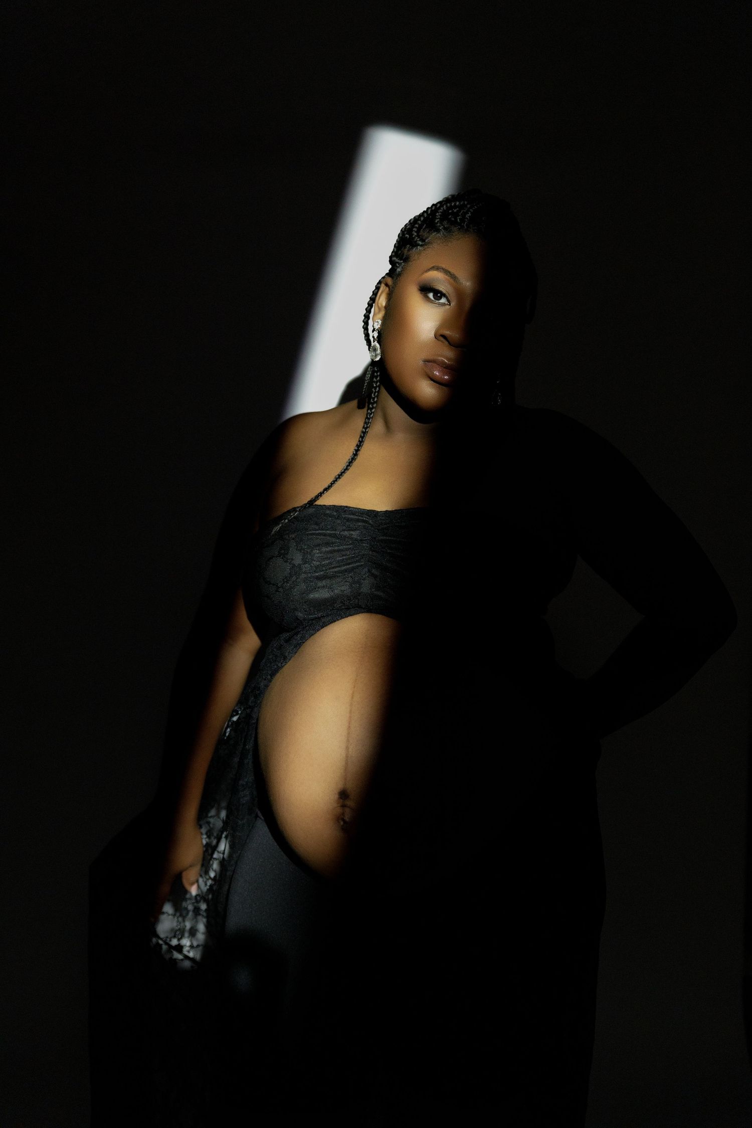 Dramatic black and white portrait series showing silhouetted figure in dark clothing against stark lighting.