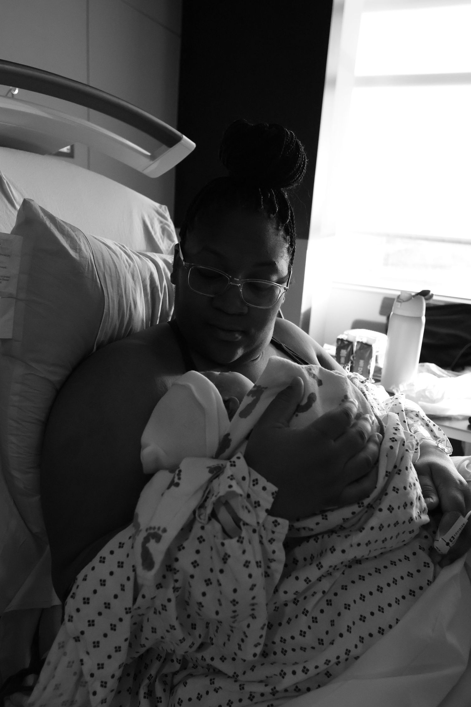 A sequence of black and white photos showing a person in a polka dot hospital gown resting in a medical bed.