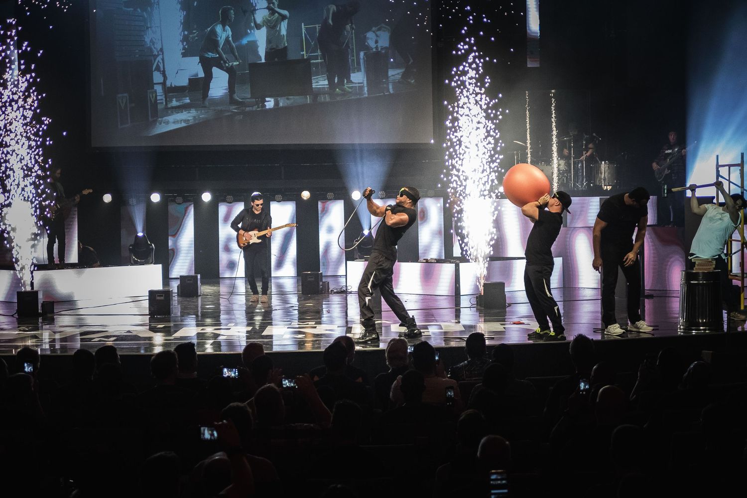 Concert stage with dramatic lighting and fog effects creates an atmospheric performance environment.