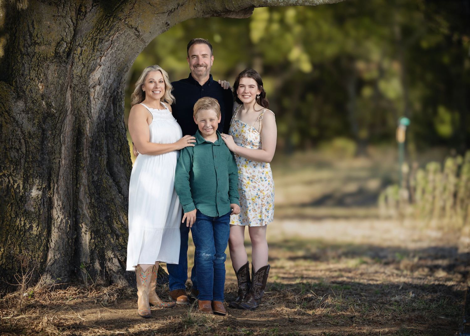 Family portrait session in wooded outdoor setting with natural lighting.