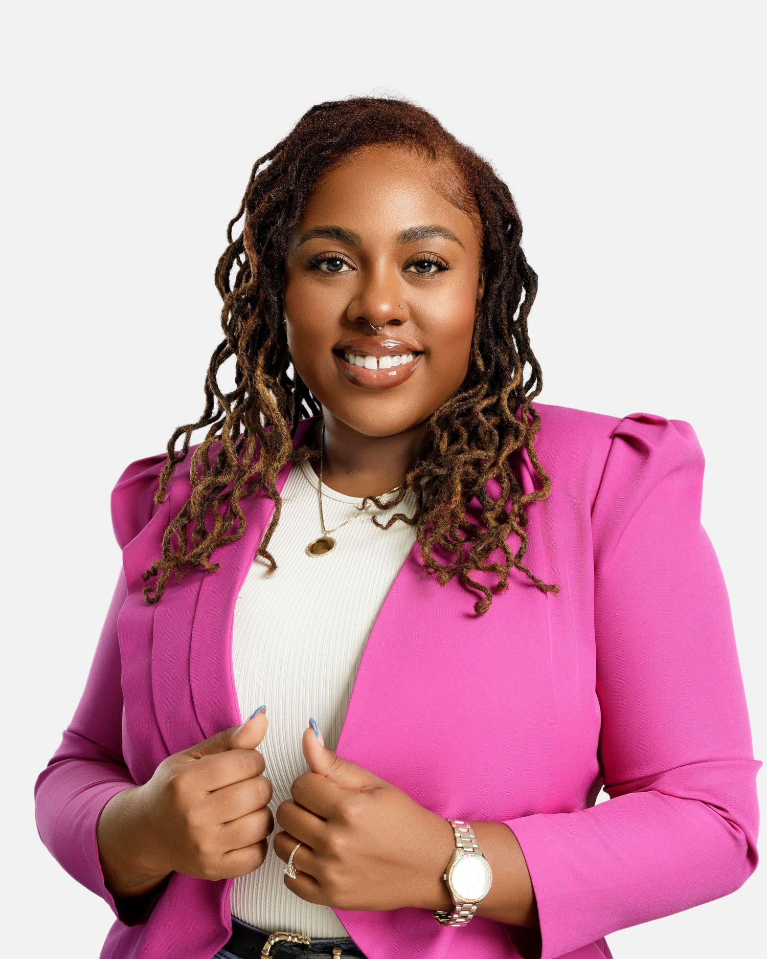 Professional portrait showing bright pink blazer and white top with confident pose against white background.