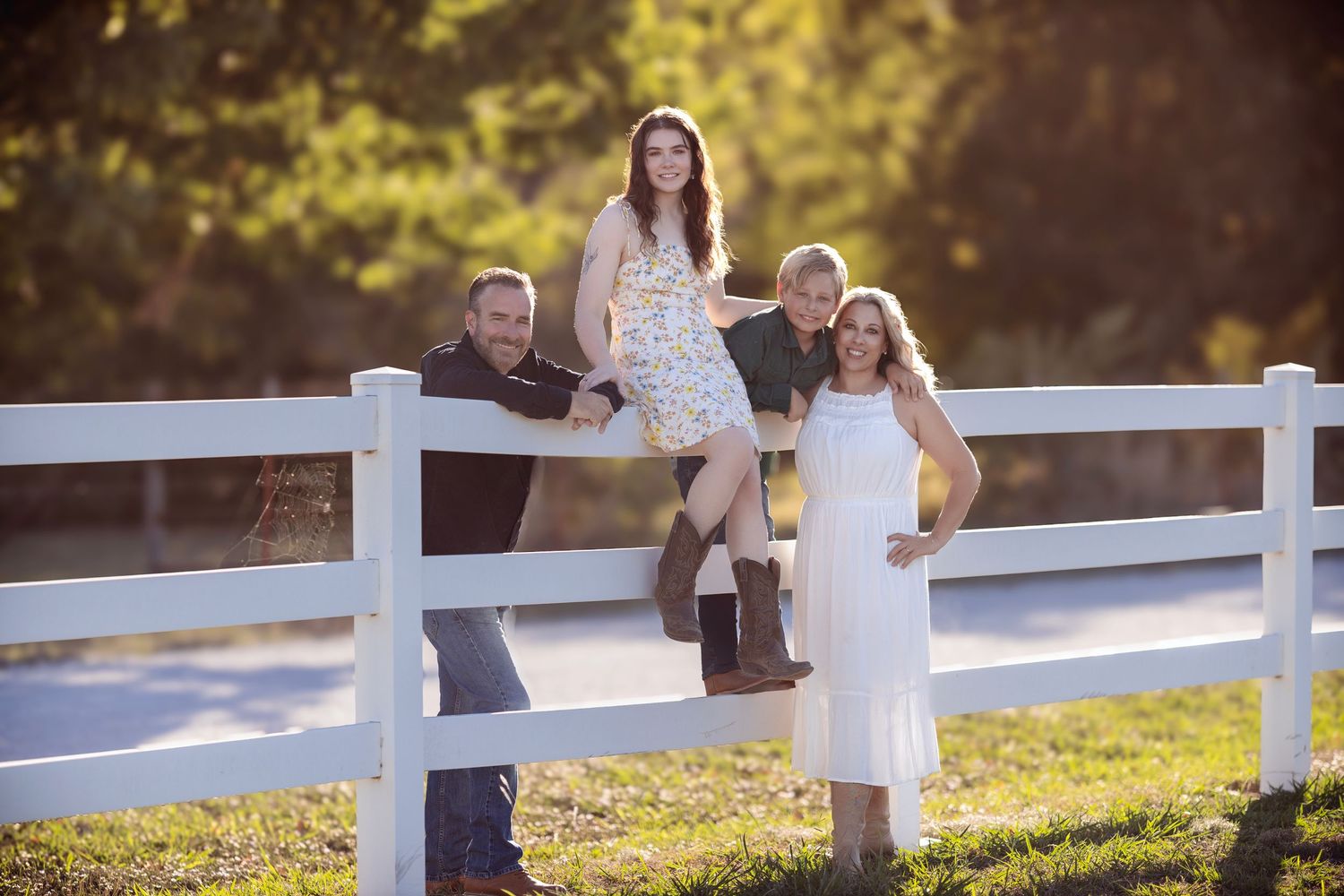 Outdoor photography session with white fence and golden hour lighting.