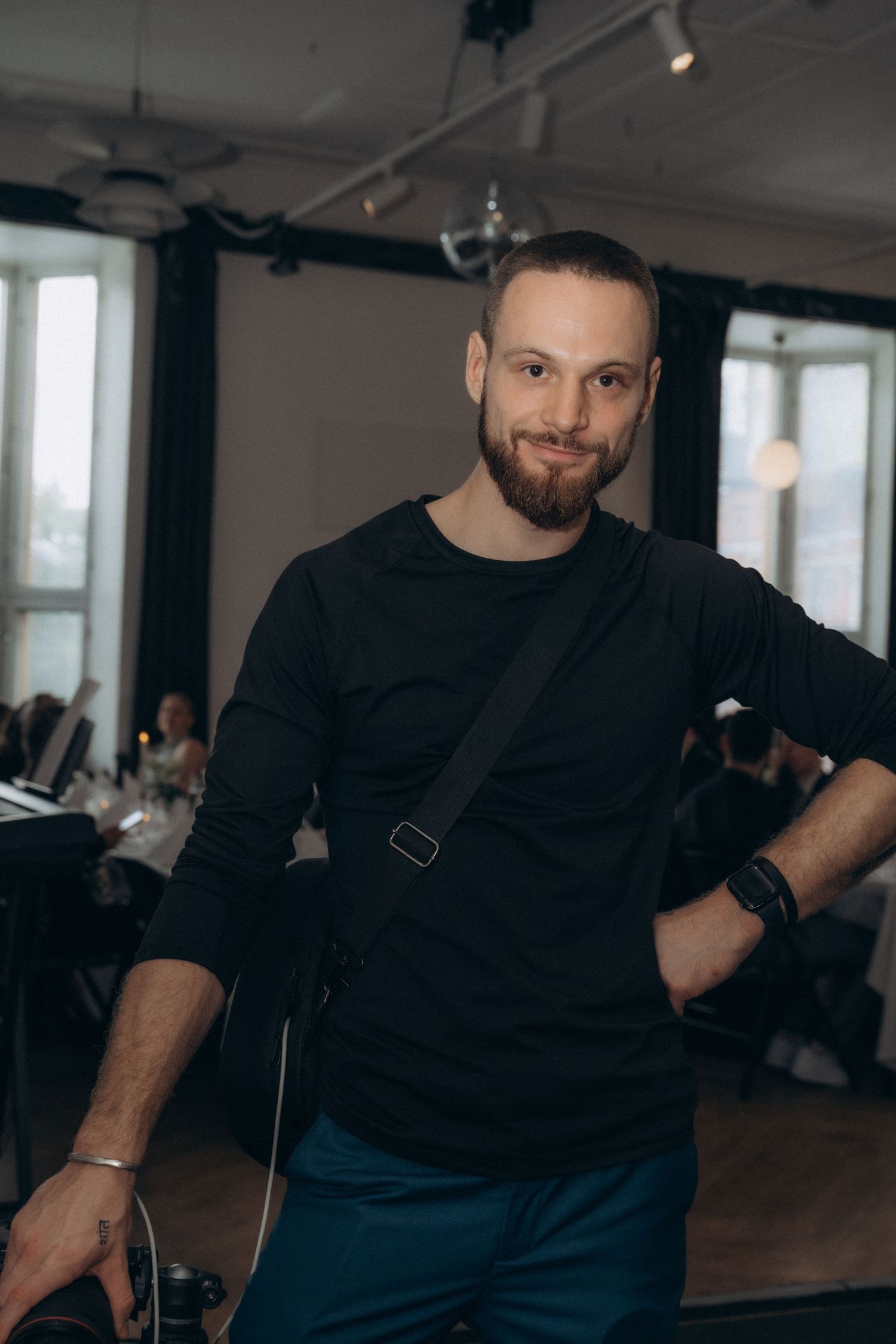 Modern wedding videographer filming reception space in Helsinki wedding venue
