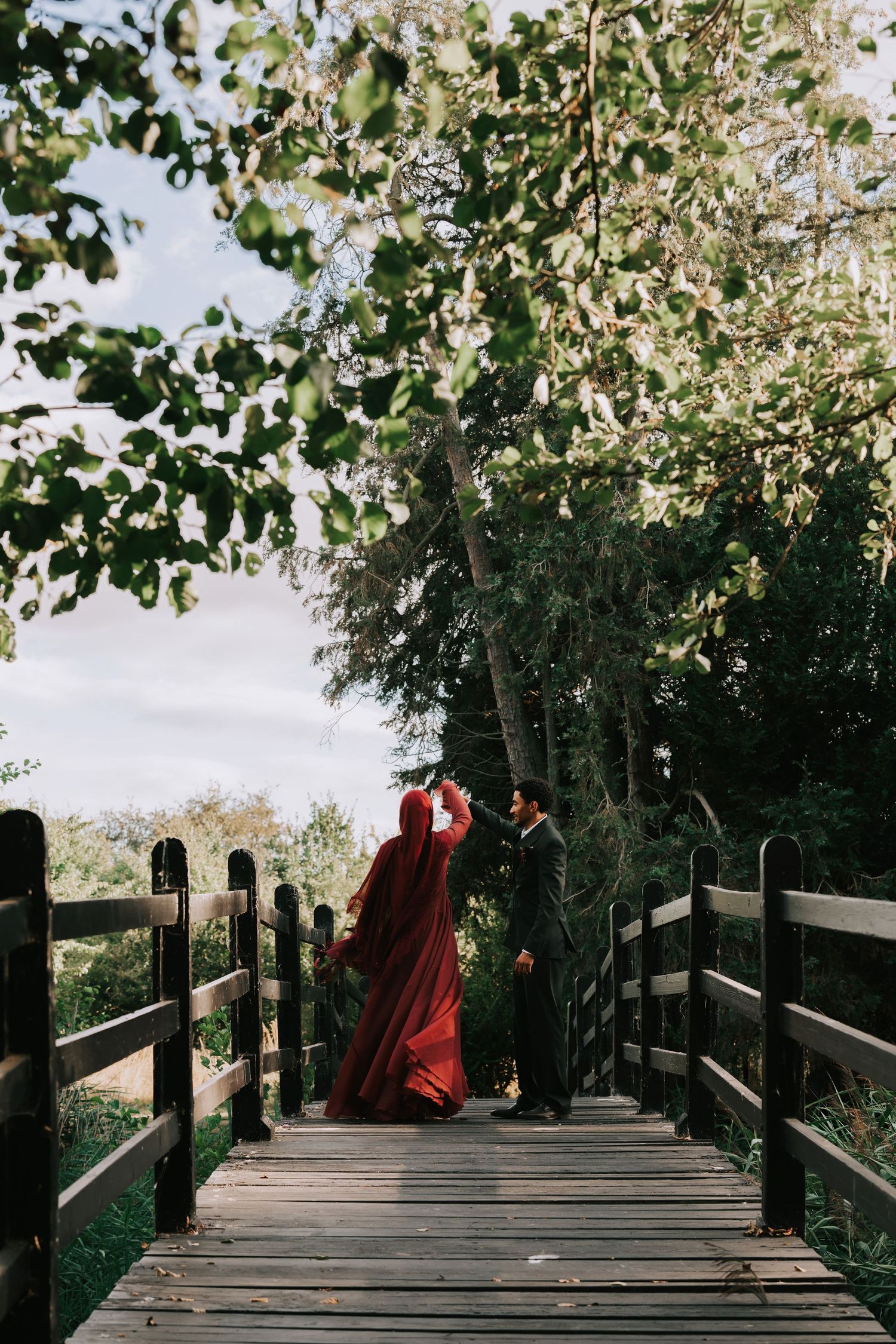 Engagement Photography Prested Hall Colchester - Couple Twirling on Wooden Bridge
