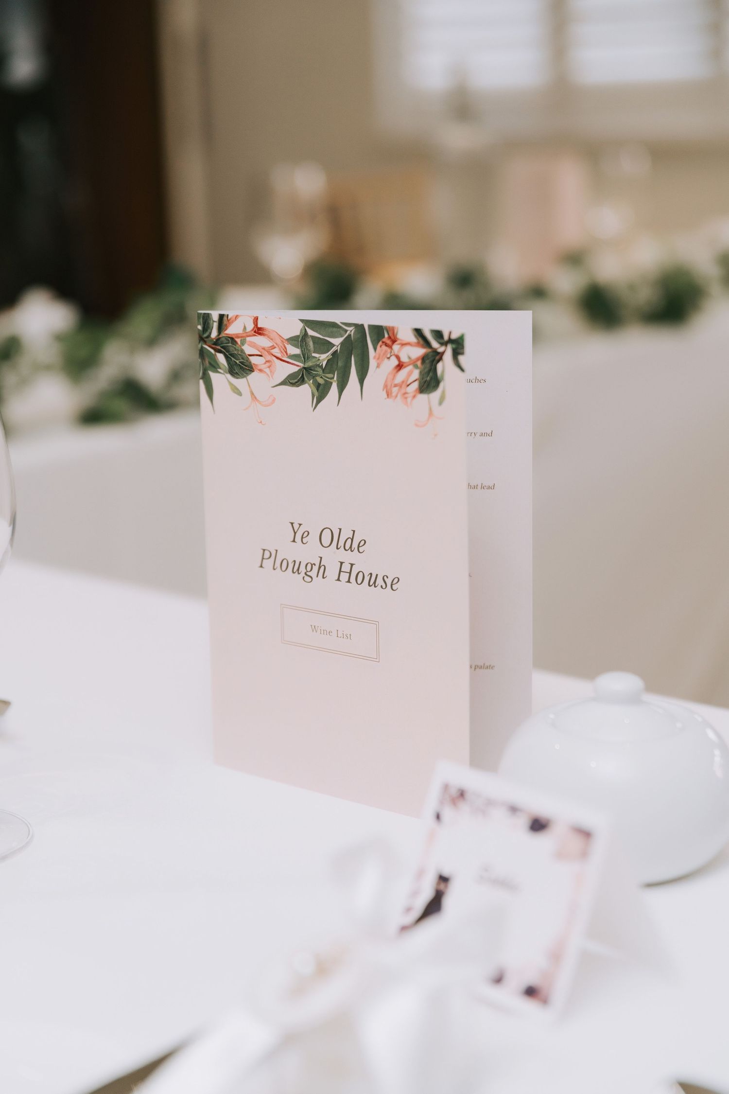 Elegant wedding menu card for Ye Olde Plough House with floral design on white table setting.