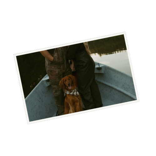 Couple relaxing on a boat with their dog during a peaceful lake outing.